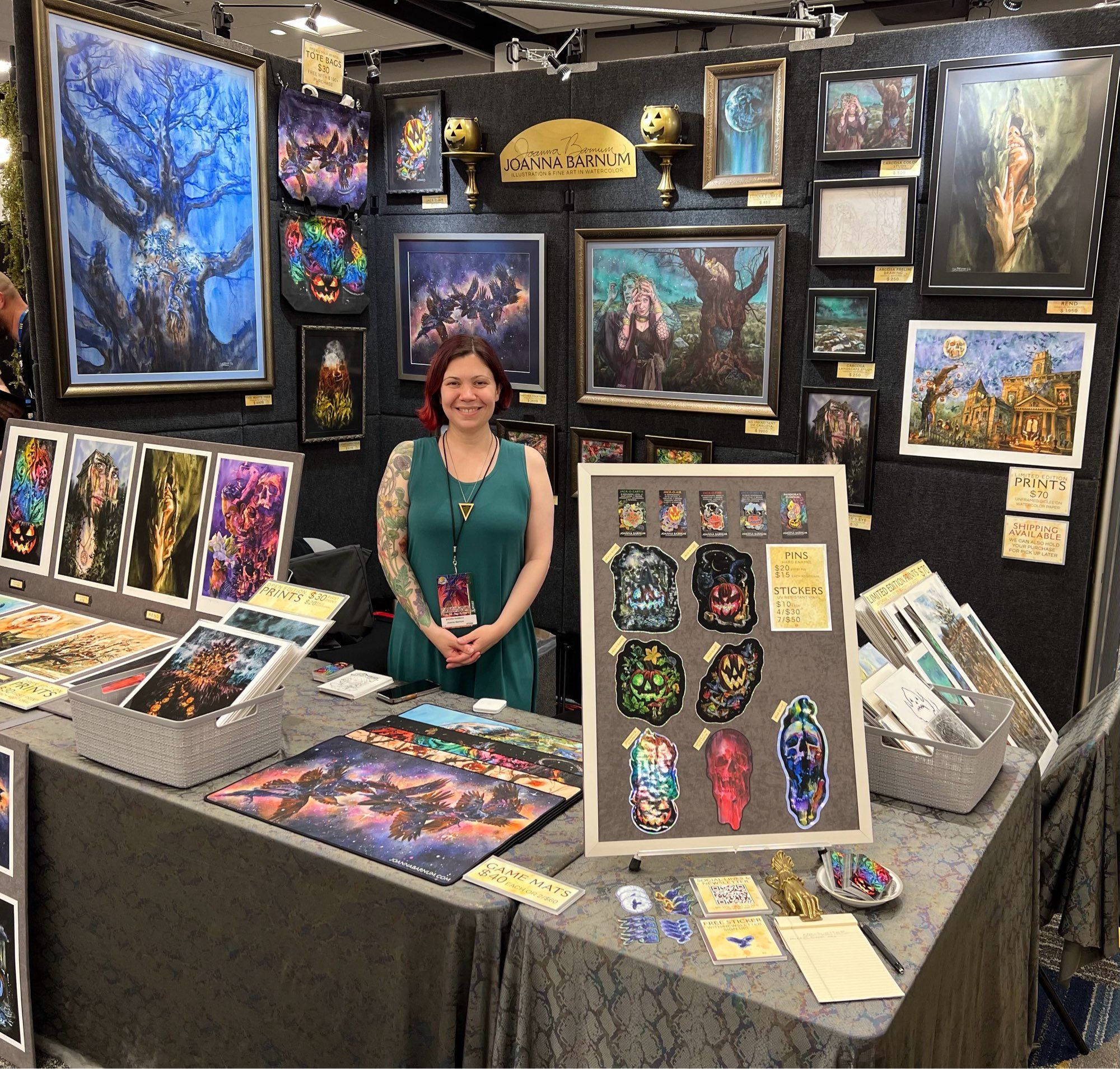 Artist posing in a vending booth with art