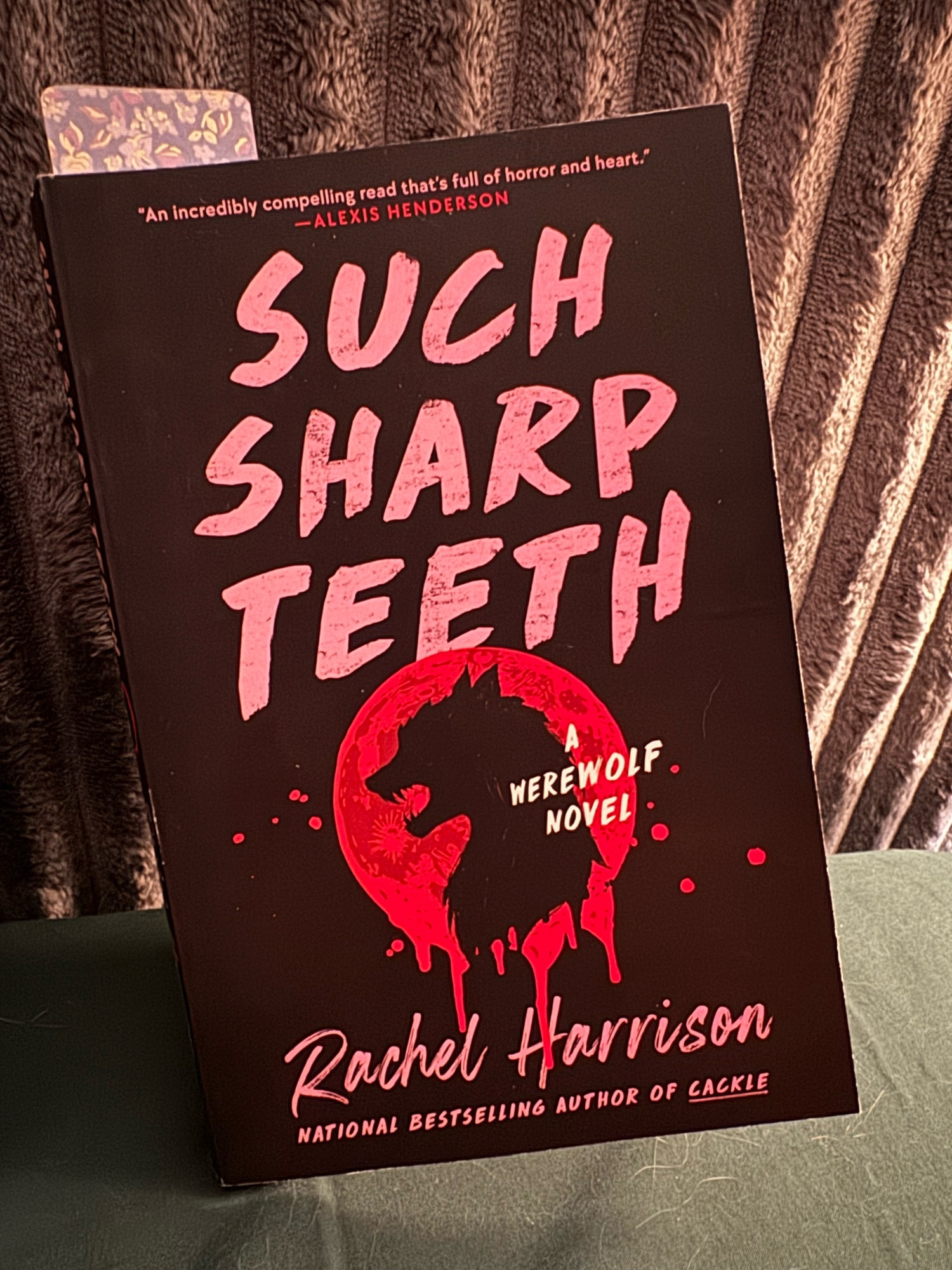 Such Sharp Teeth: A Werewolf Novel by Rachel Harrison! Cover features a bleeding moon with the shadow of a werewolf head. Real cool stuff.