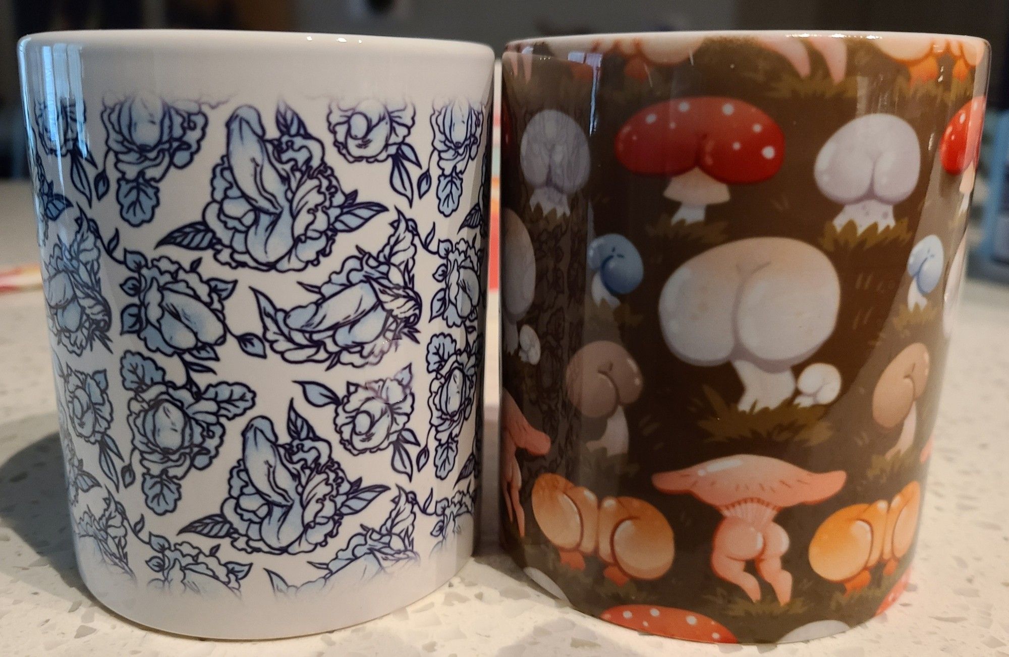 2 coffee mugs, one with tasteful floral penises and another with luscious mushroom butts