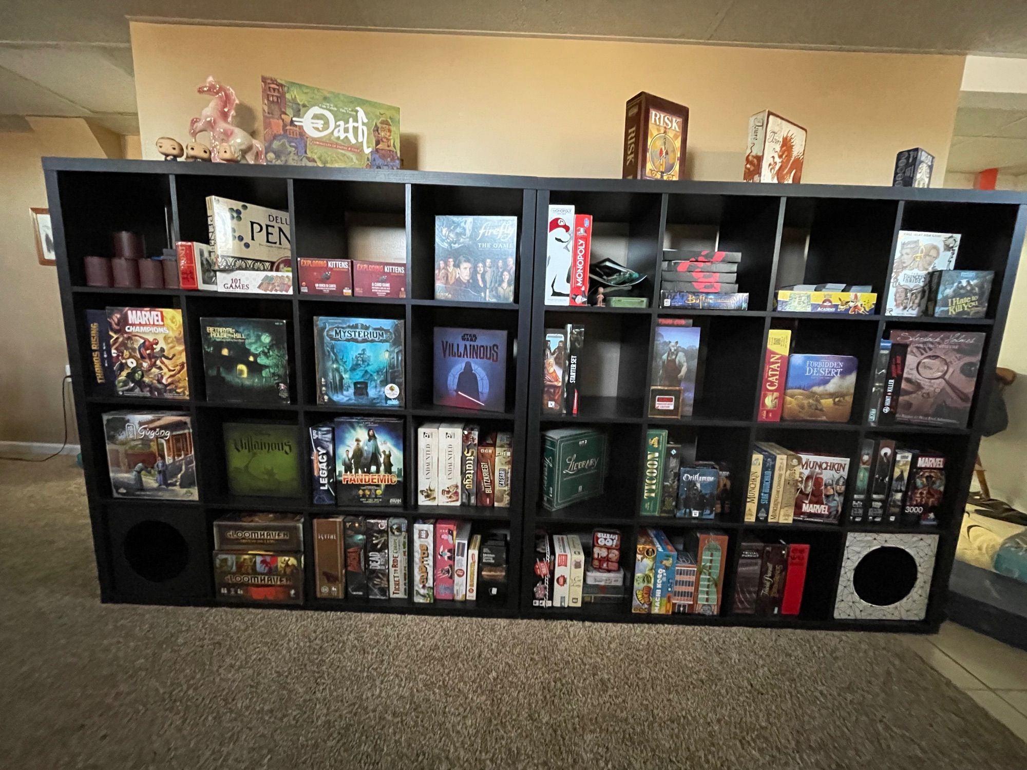 two 5x5 ikea kallax shelves with many board games, including Oath, Risk, Twuro, Skull, Munchkin, Princess Bride, Final Girl S1, Mysterium, Cat Lady, Monikers, Pandemic, Undaunted. Gloomhaven & Jaws of the Lion, Betrayal at House on the Hill, and many many more