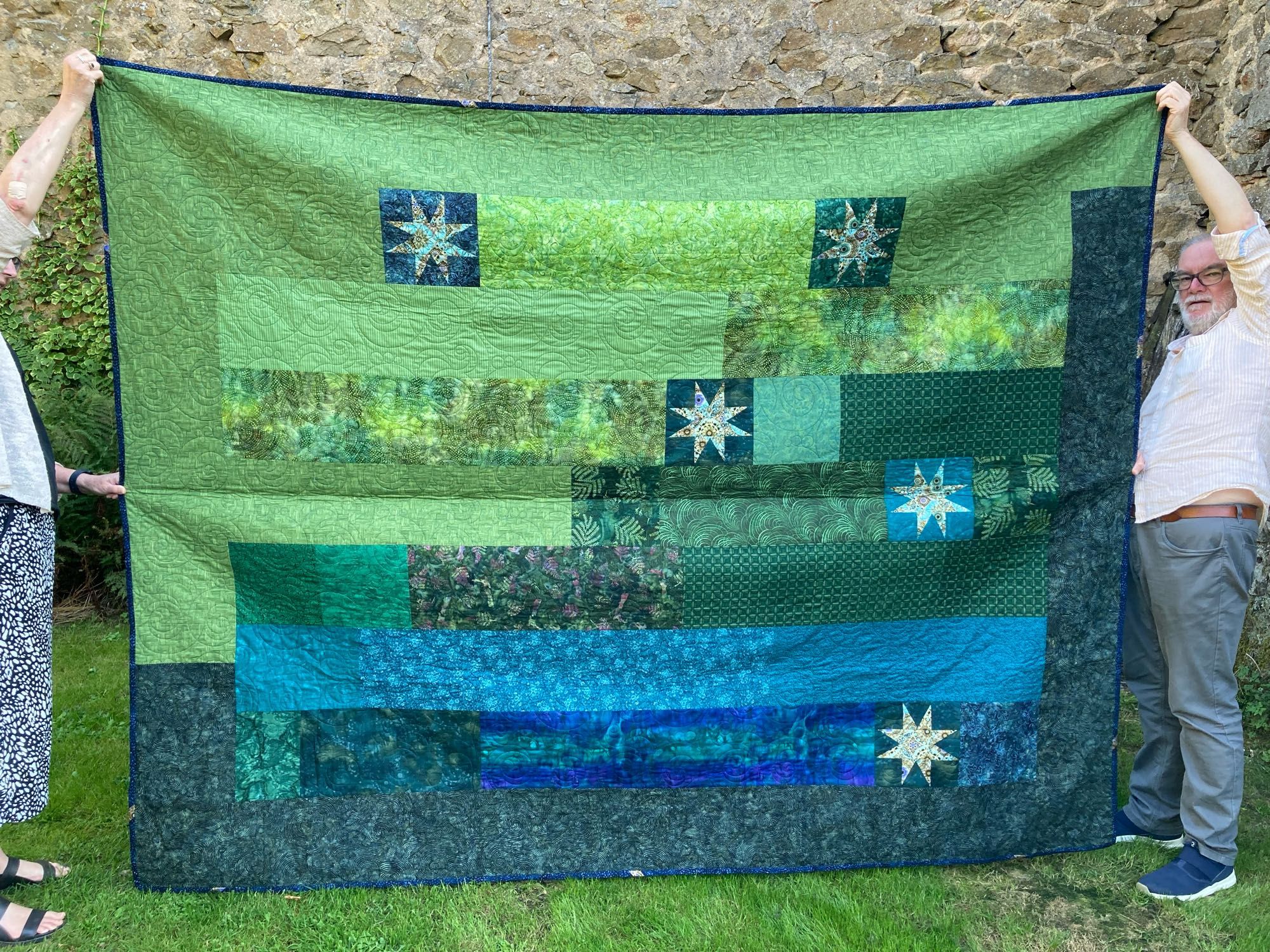 Green and blue quilt with stars