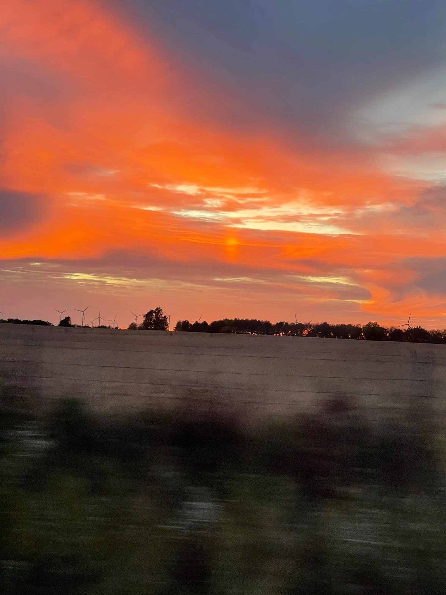 digital photo of a fiery sunset over an open field