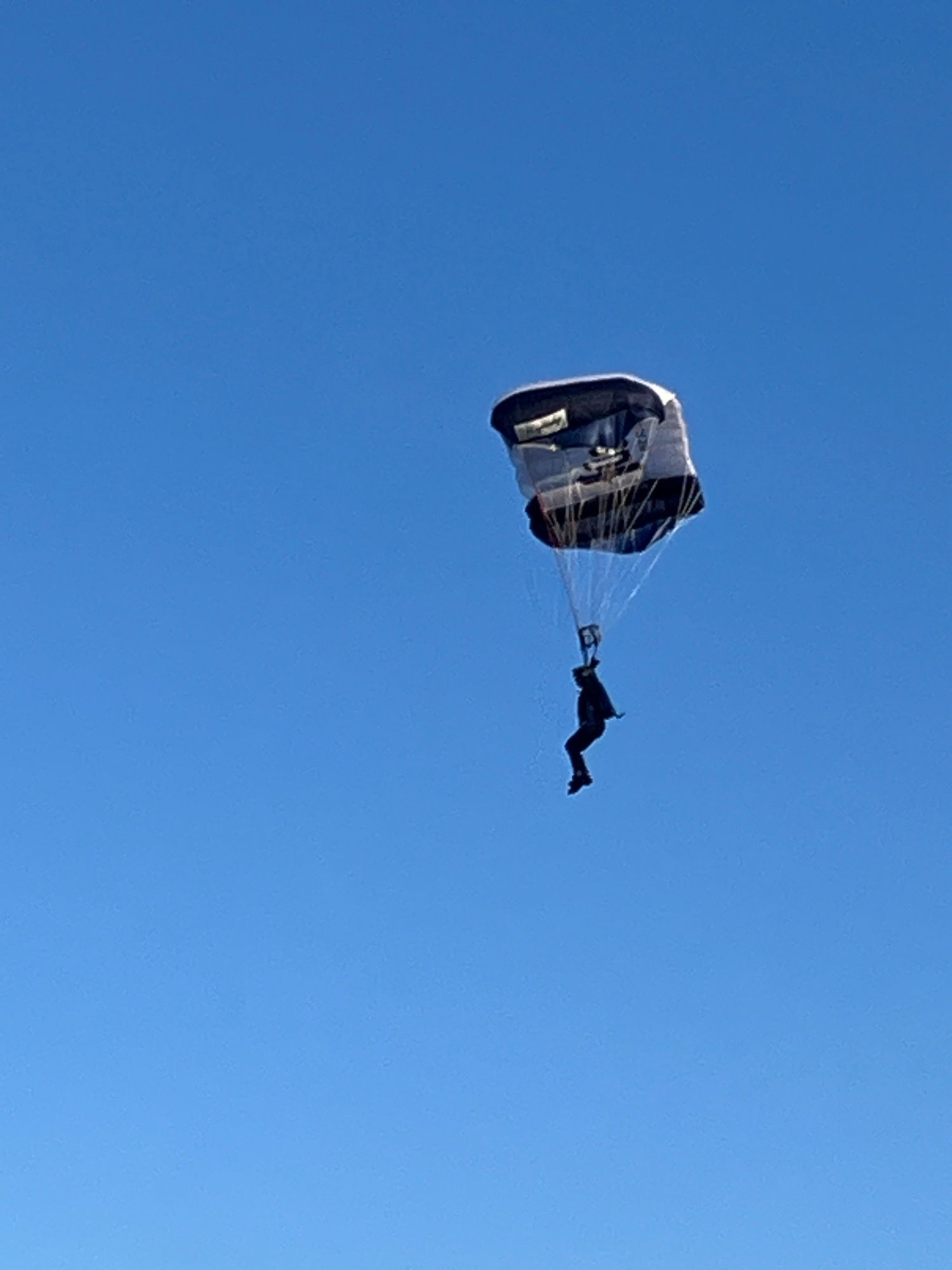 Ein Fallschirmspringer vor blauem Himmel