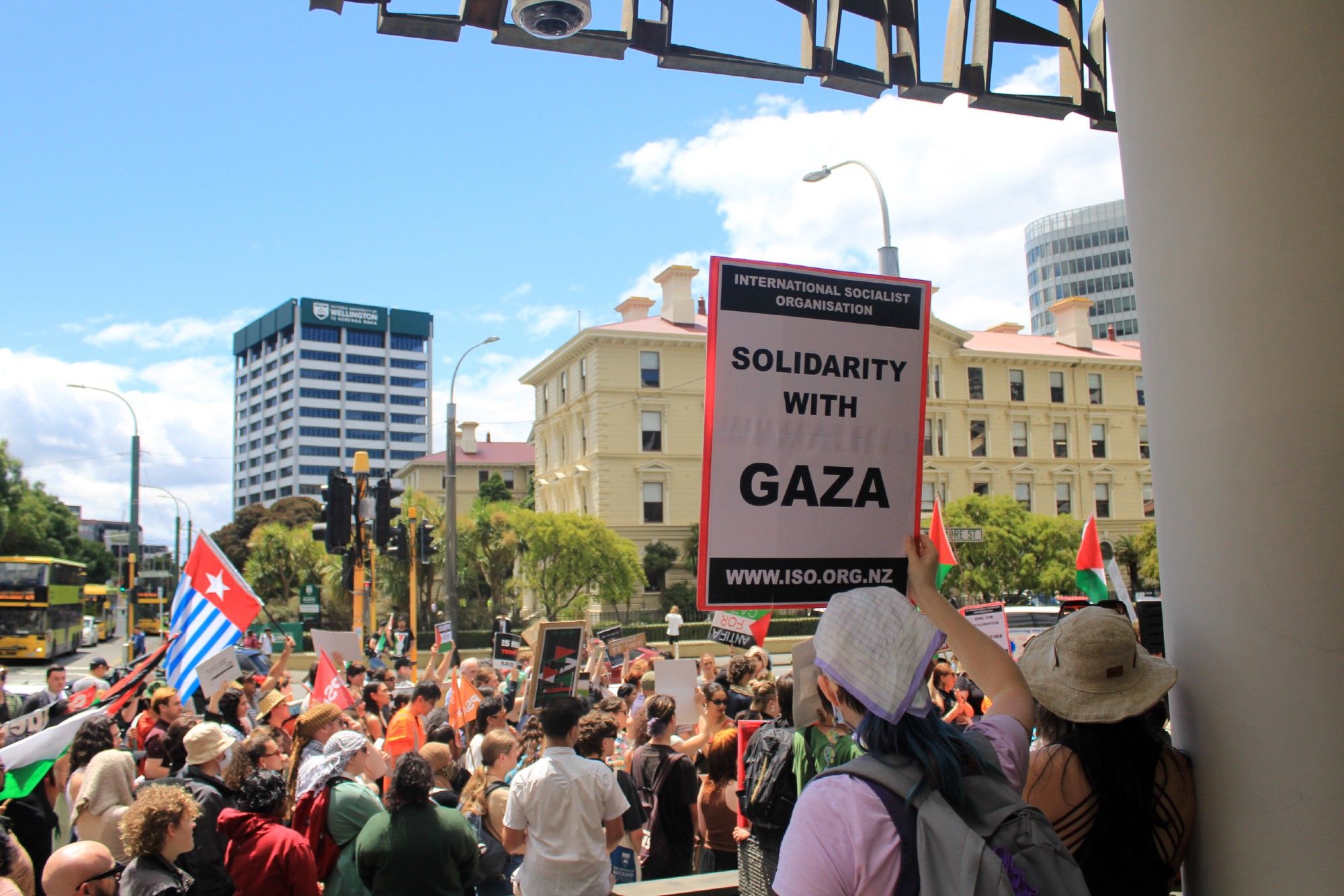 Pōneke Anti-Fascist Coalition and hundreds of supporters rally for Gaza outside the New Zealand Supreme Court in Wellington, in defiance of Zionist, Islamophobic  hatemongers like Brian Tamaki and Destiny Church, with signs that say Solidarity with Gaza.