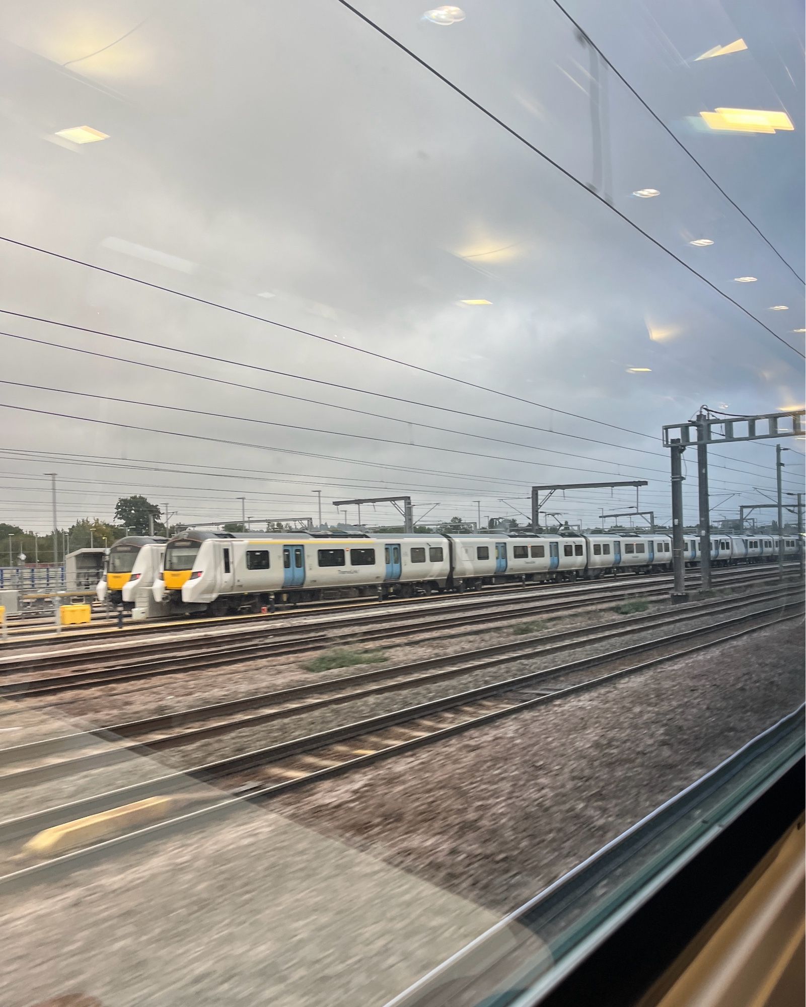 Photo looking out the window of a train carriage at other trains. Not the thirst traps you usually see here…