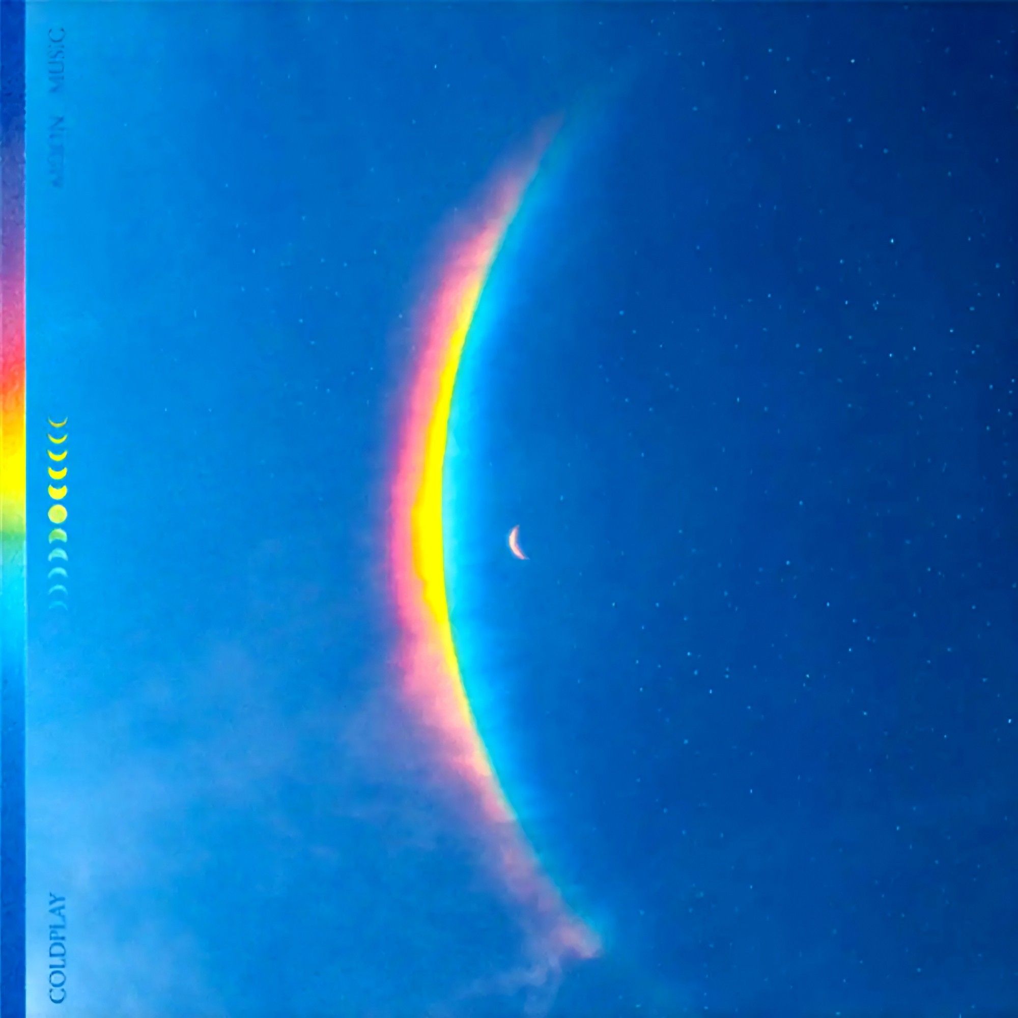 Album cover for Moon Music by Coldplay. Looks like a view of the night sky, with a rainbow stretching vertically as if it's the corona of a solar eclipse.