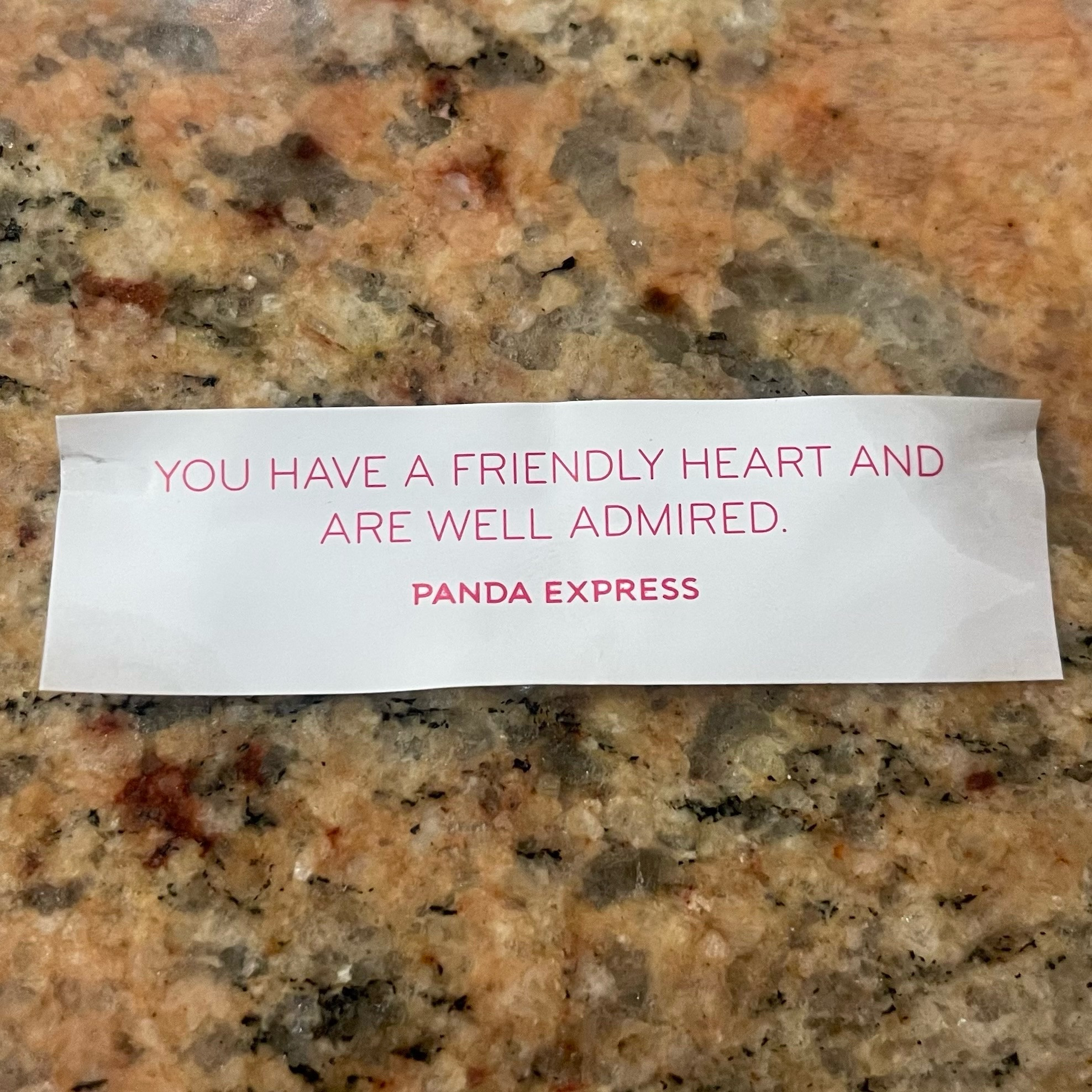 A fortune from a Panda Express fortune cookie which reads, “You have a friendly heart and are well admired.”