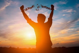 man breaking free from chains stock photo