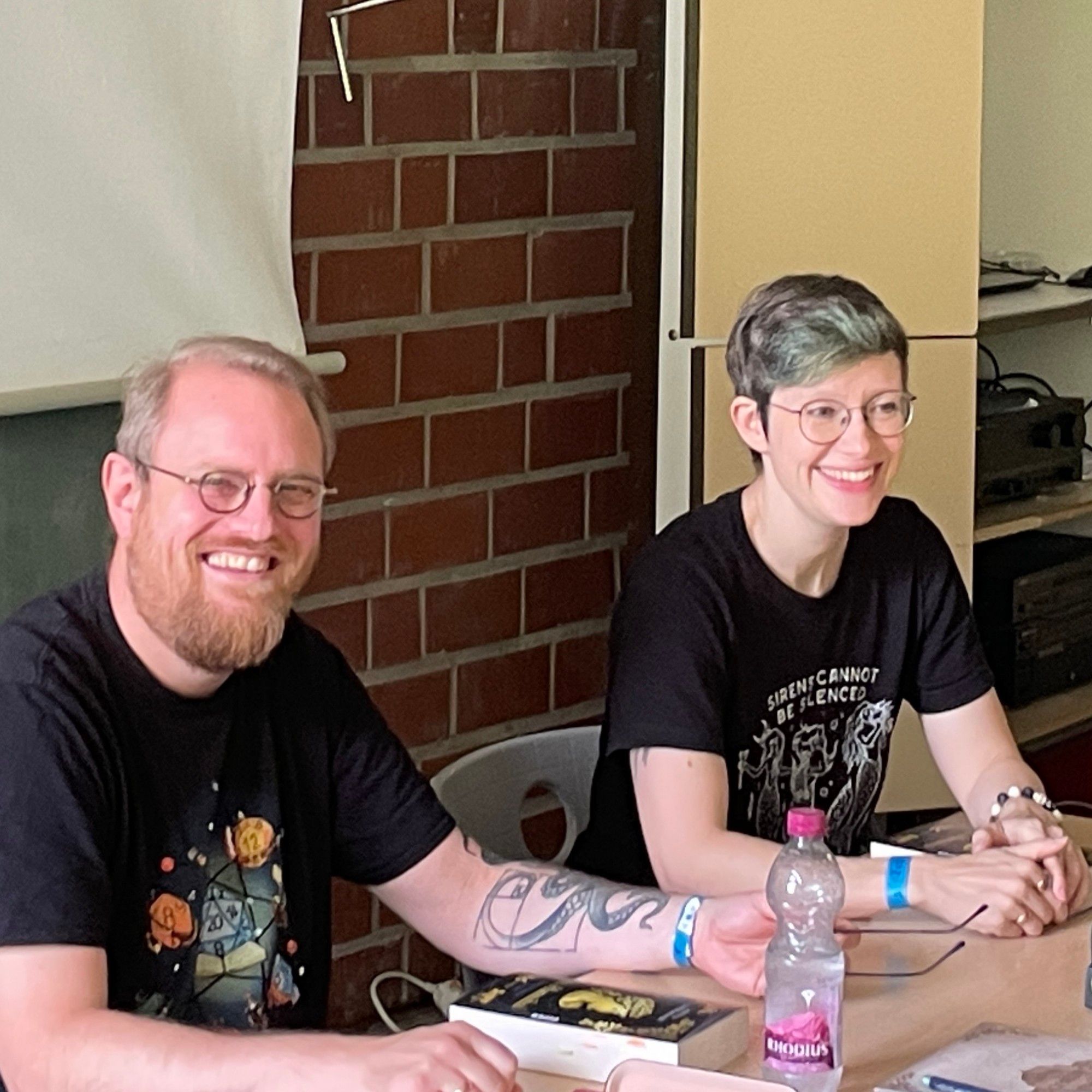 Christian und Judith mit Ich, Hannibal in einem Klassenraum, grinsend.