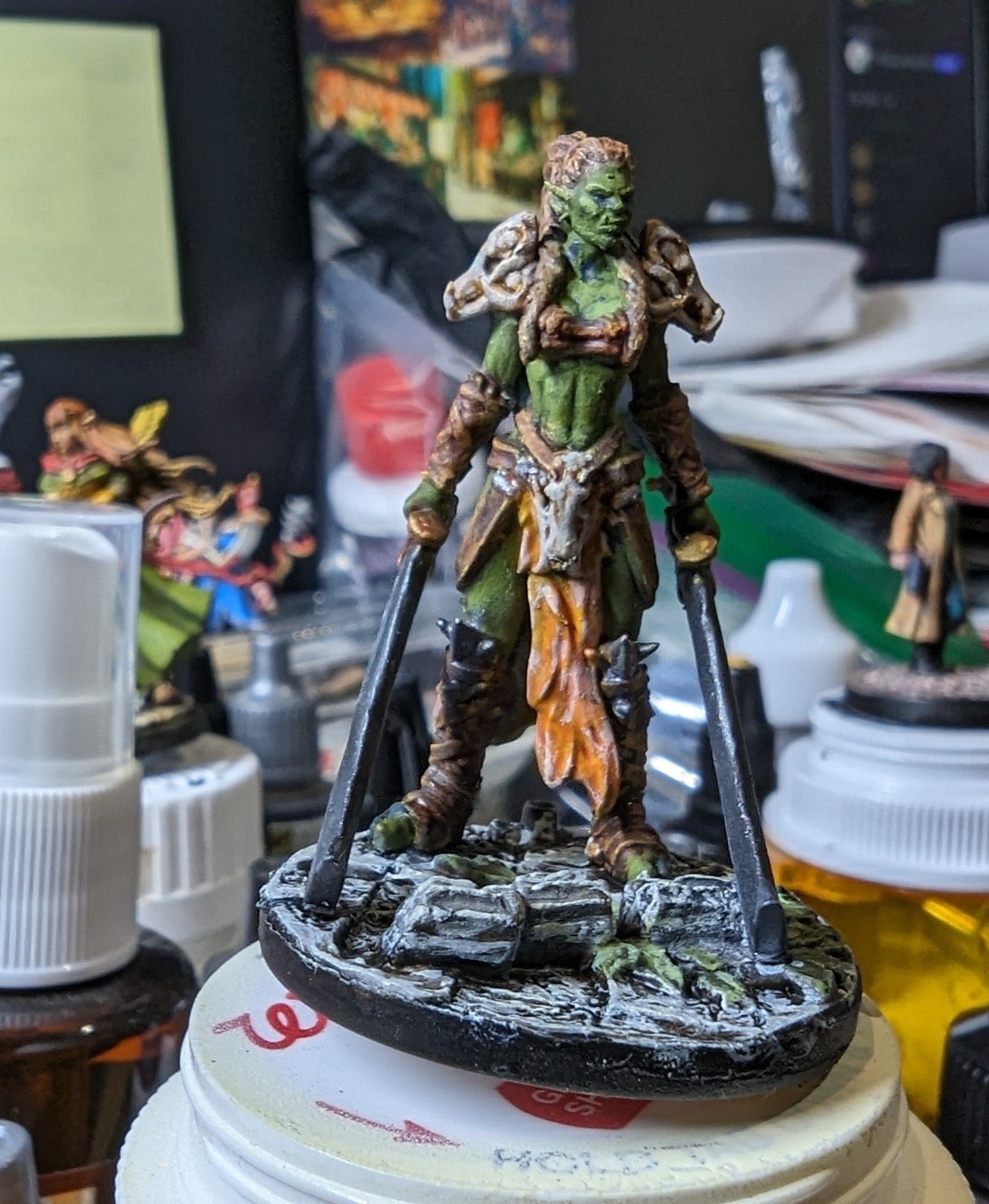 A painted miniature figurine of an Orc fighter from Printed Obsession