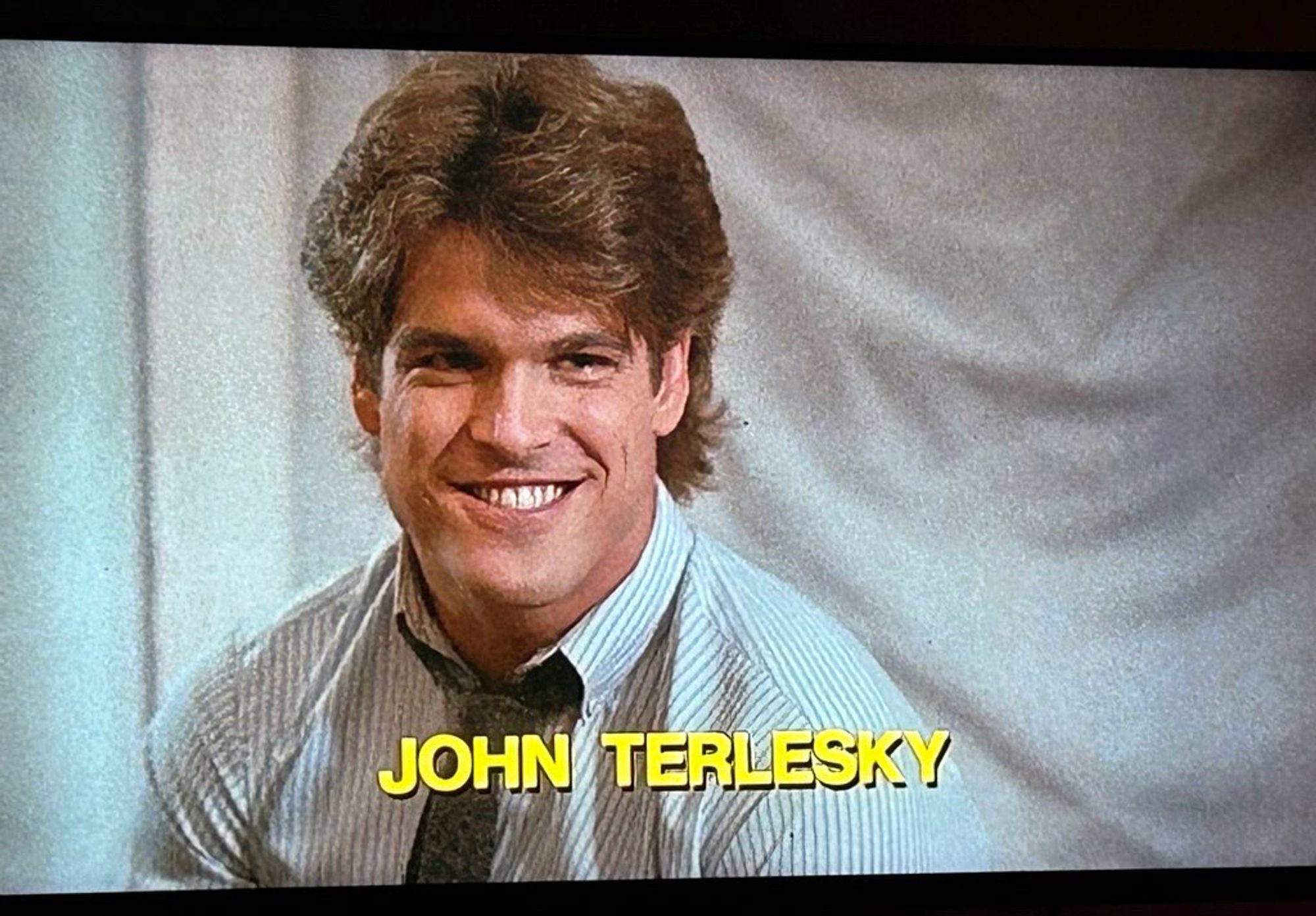 John Terlesky in the credits of Chopping Mall, which features a short clip of each actor in the movie then shows their name over a freeze frame.