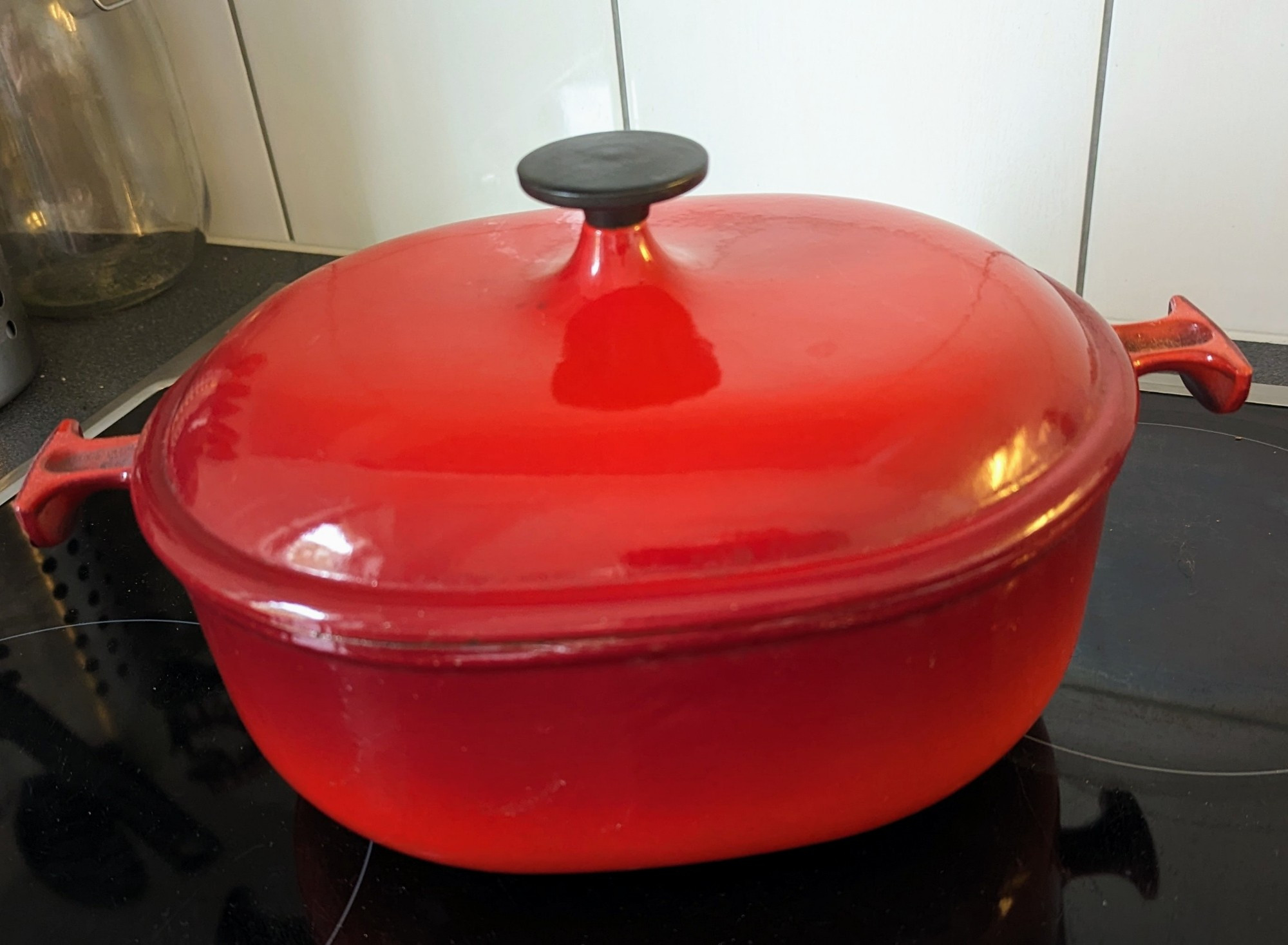 Old Le Creuset cocotte, cherry red colored.