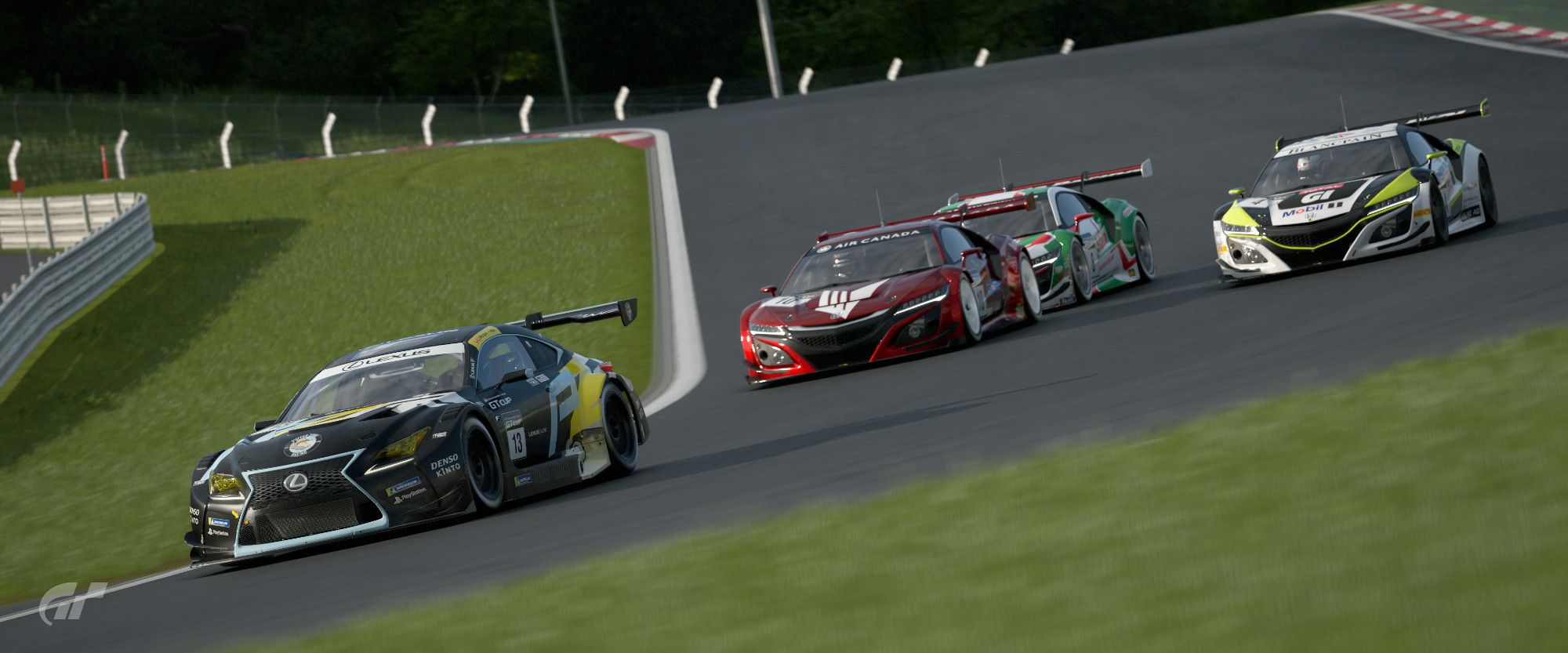 A screenshot from Gran Turismo 7. It features four race cars battling for position exiting the first two turns at Fuji Speedway. Out in front is a matte black with light blue Lexus RC F GT3, and then two car lengths behind is a trio of Honda NSX Group 3 cars being led by a red one. On it's left flank, viewer's right, is a white with yellow and black NSX, with a white with red and green NSX closely behind the red NSX.