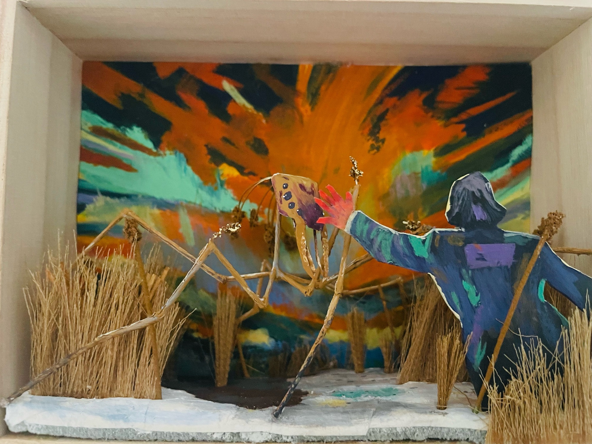 A 4x6 diorama of the art from Disco Elysium in which Harry is reaching out to pet the Insulindian phasmid. The background is painted on, a vivid orange and blue sunset. The insulindian phasmid is a giant stick bug that blends in the reeds, it is made out of paper and thick twine. There are fake reeds made out of fake plant parts. And Harry is cut out from chipboard paper and painted 