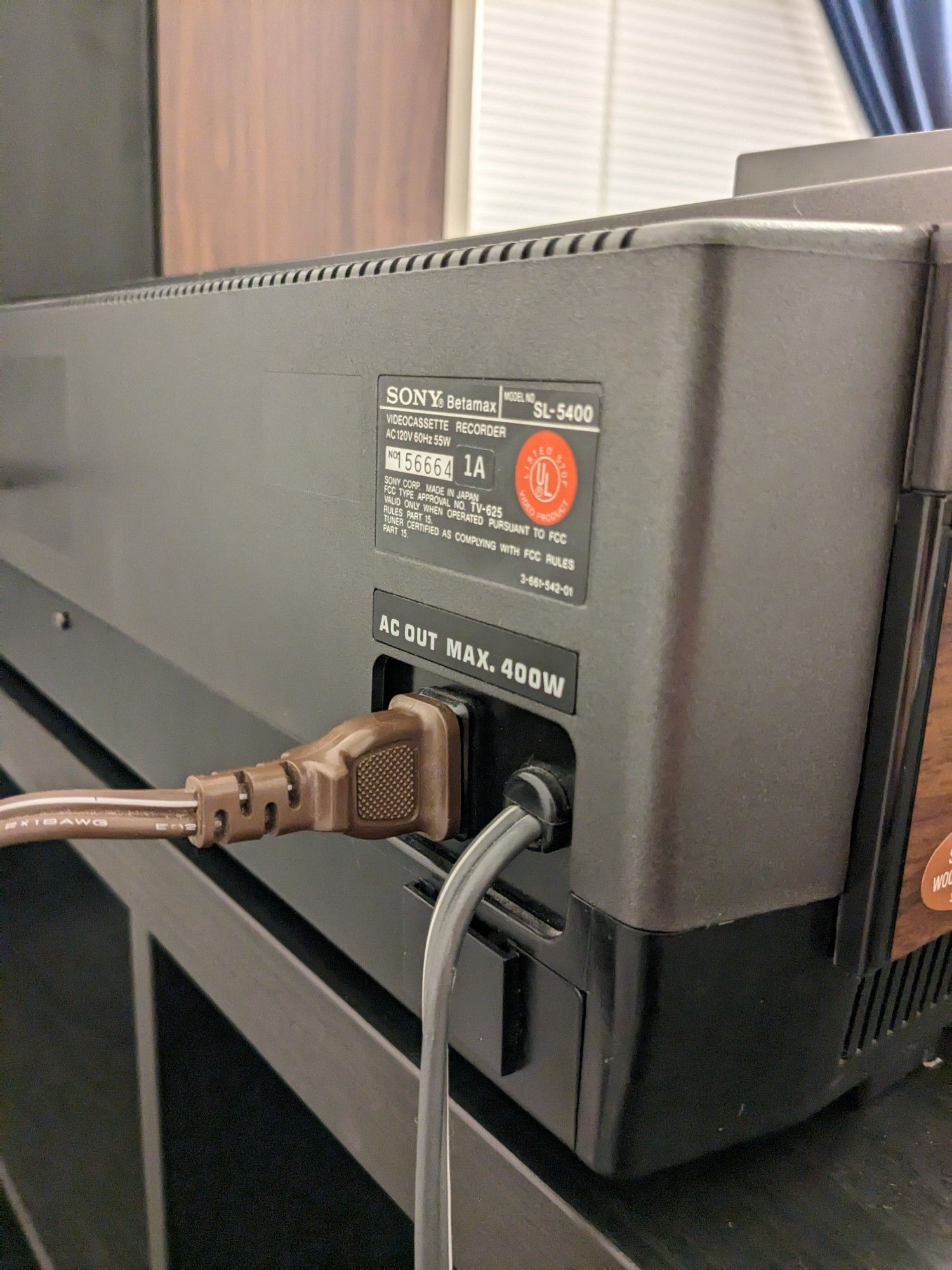 The rear of a Sony Betamax SL-5400 showing a power plug inserted to an AC-out receptacle (labelled max 400W)