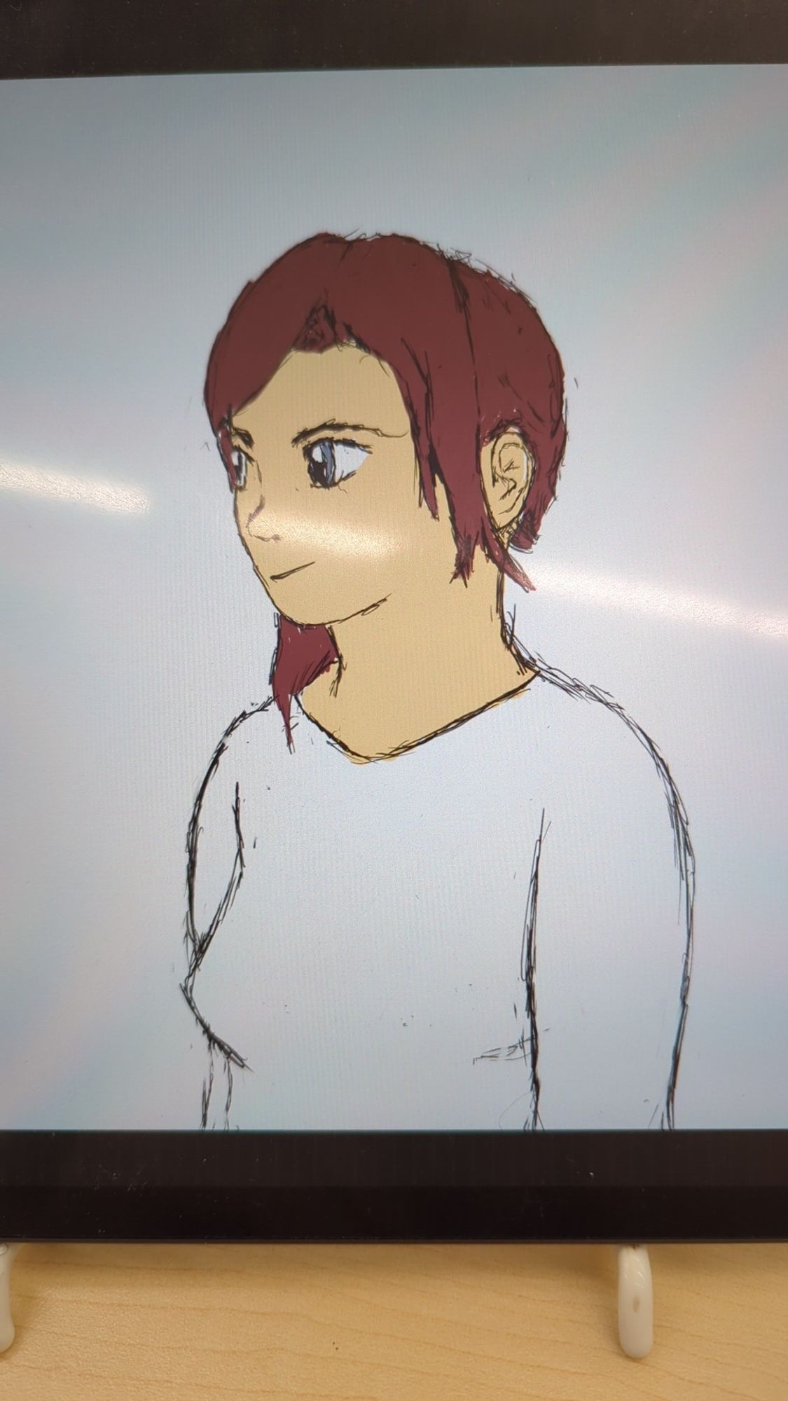 photo of my iPad screen on a stand showing a vaguely anime-esquebdraeinf that kinda resembles me. The hair is dark red and she is wearing a white shirt because it hasn't been coloured in yet.