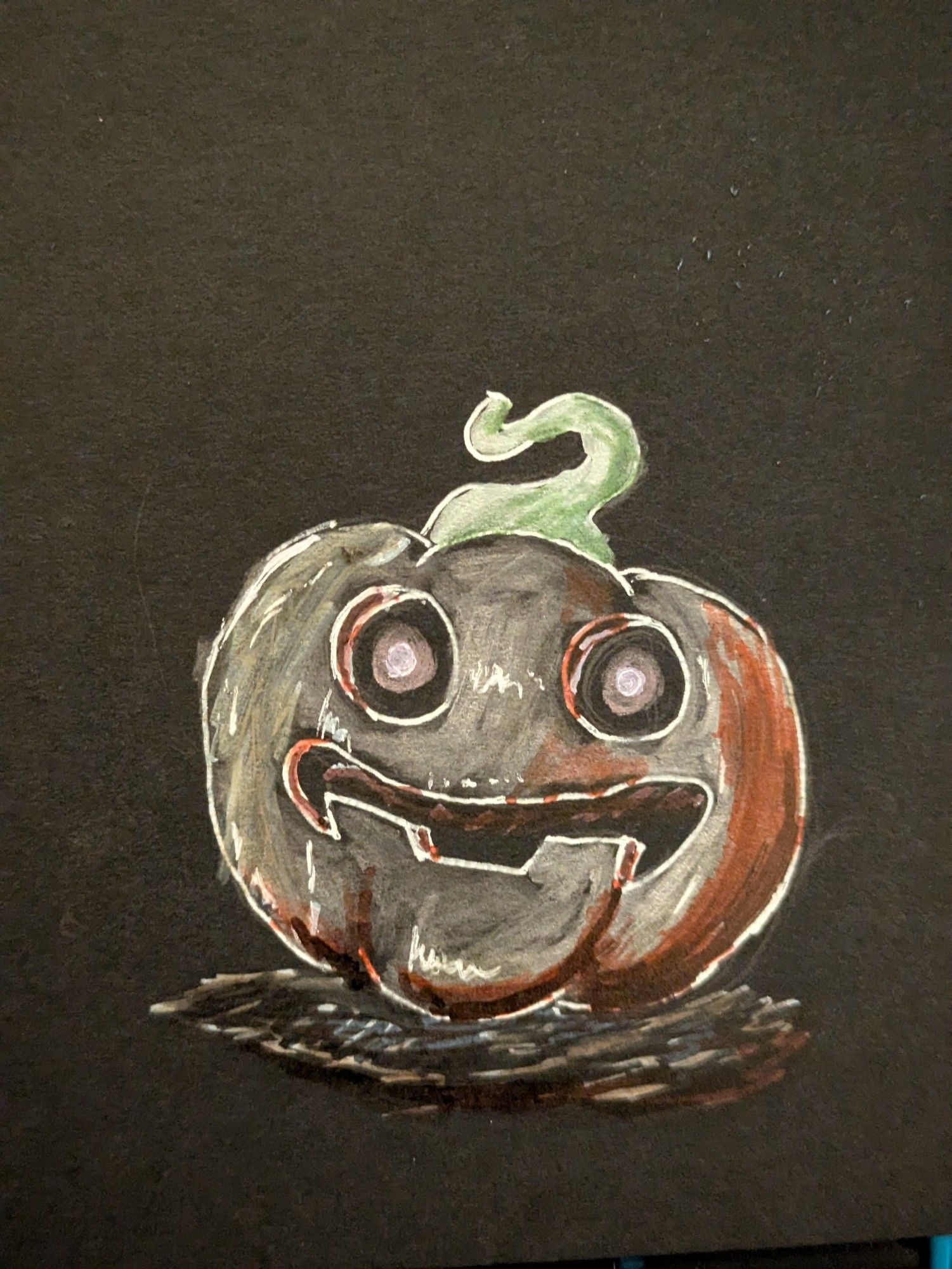 A jack o lantern drawn on black paper using metallic sharpies and white pens