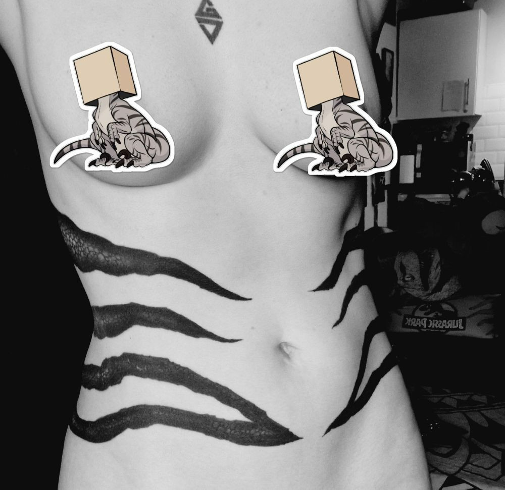 A greyscale photo of Pye's stomach. They have three bands of black stripes tattooed, to match their sona. The tattoos are detailed to look like reptile scales.