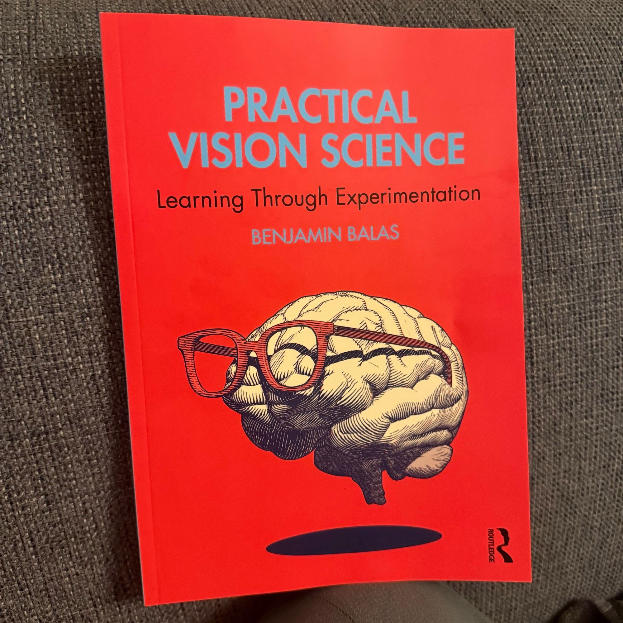 A red book, titled practical vision science.