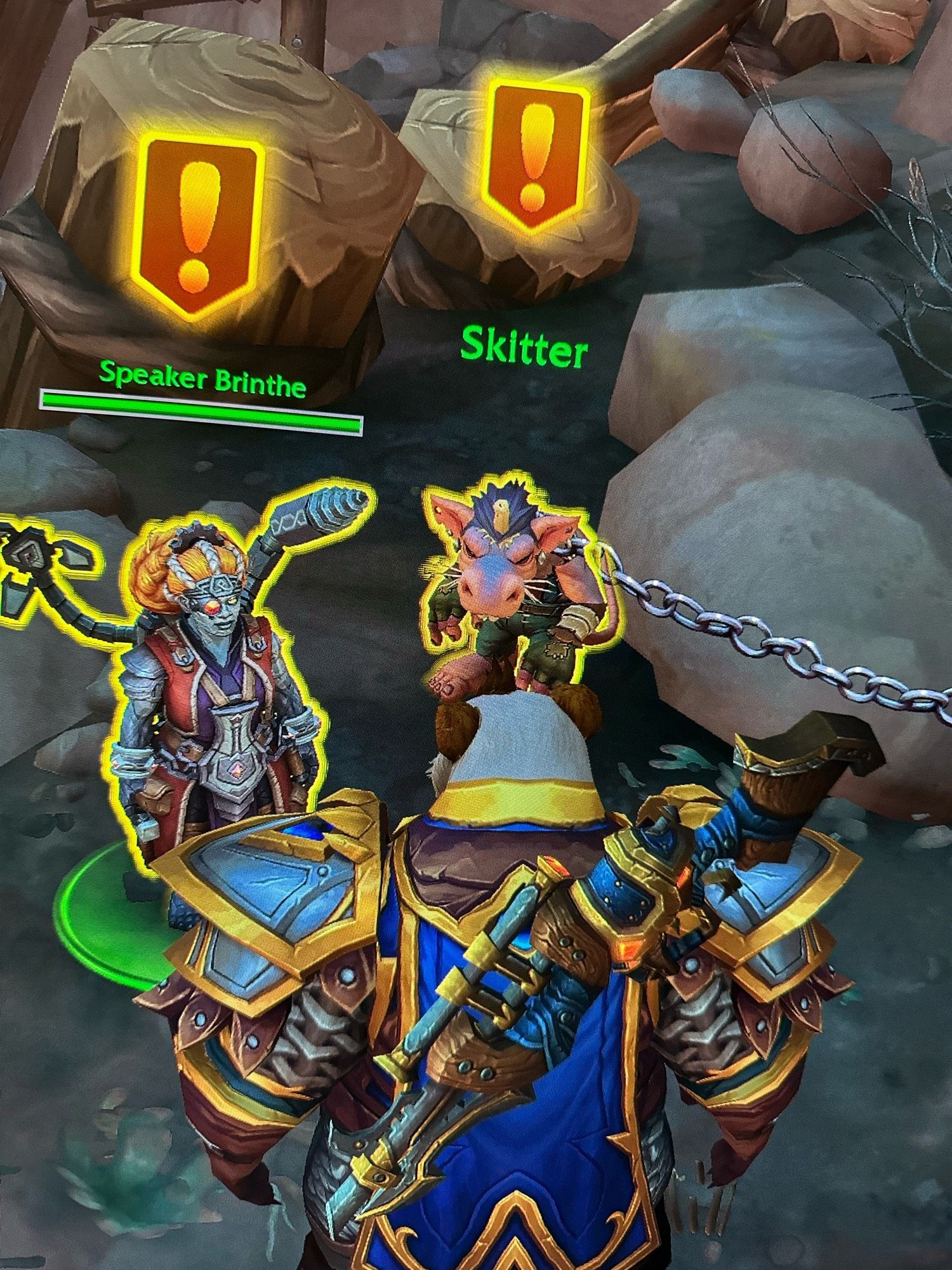 Screenshot of World of Warcraft, Tawnybrow the Pandaren stands in front of Speaker Brinthe and Skitter, the super ultra cute kobold and focus of this image