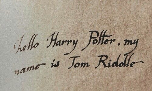 Calligraphy written with a quill that says “hello Harry Potter, my name is Tom Riddle”