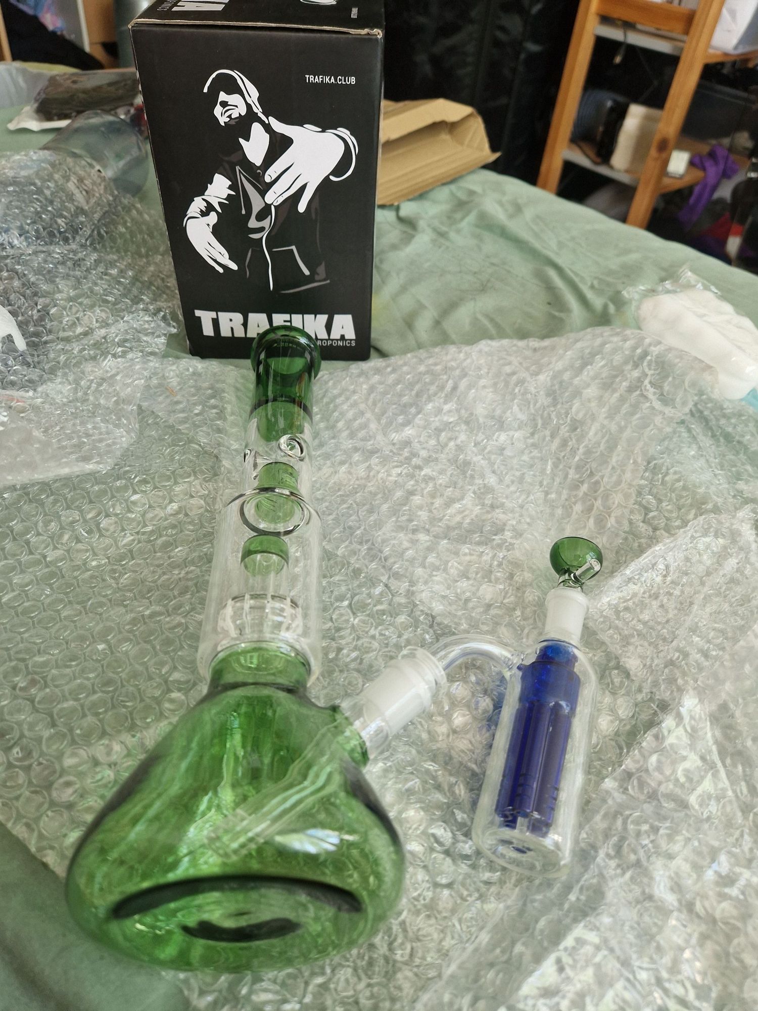 swag ass bong with pic of swag ass dude on a box behind it