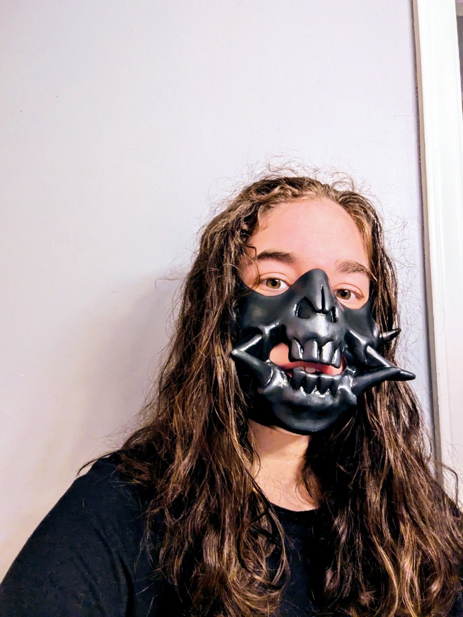 me, wearing my finished half mask. it's painted black and has a gloss coat on it