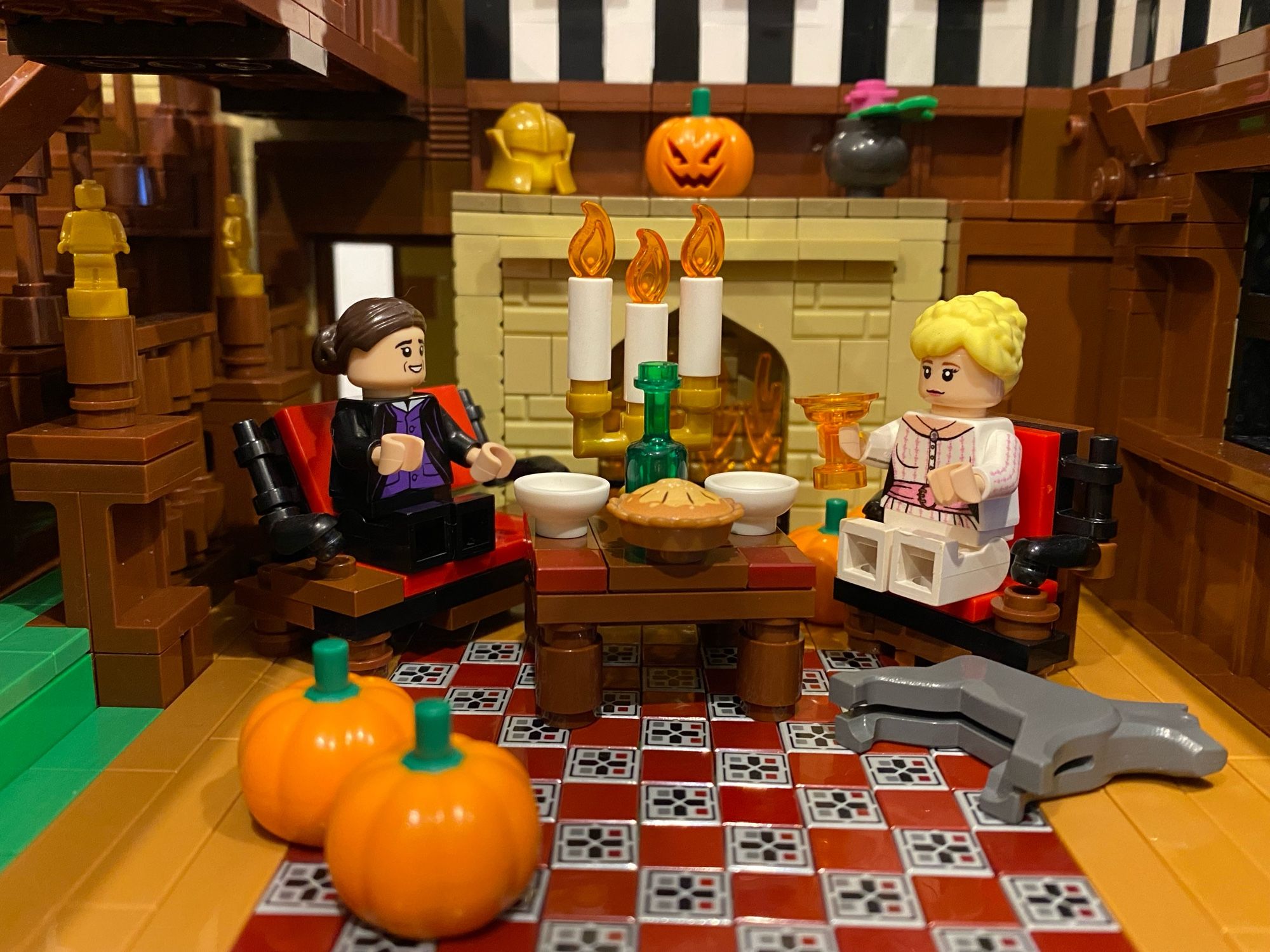 Lego Anne Lister and Ann Walker with dog Argus, having a candle light dinner at Lego Shibden Hall.