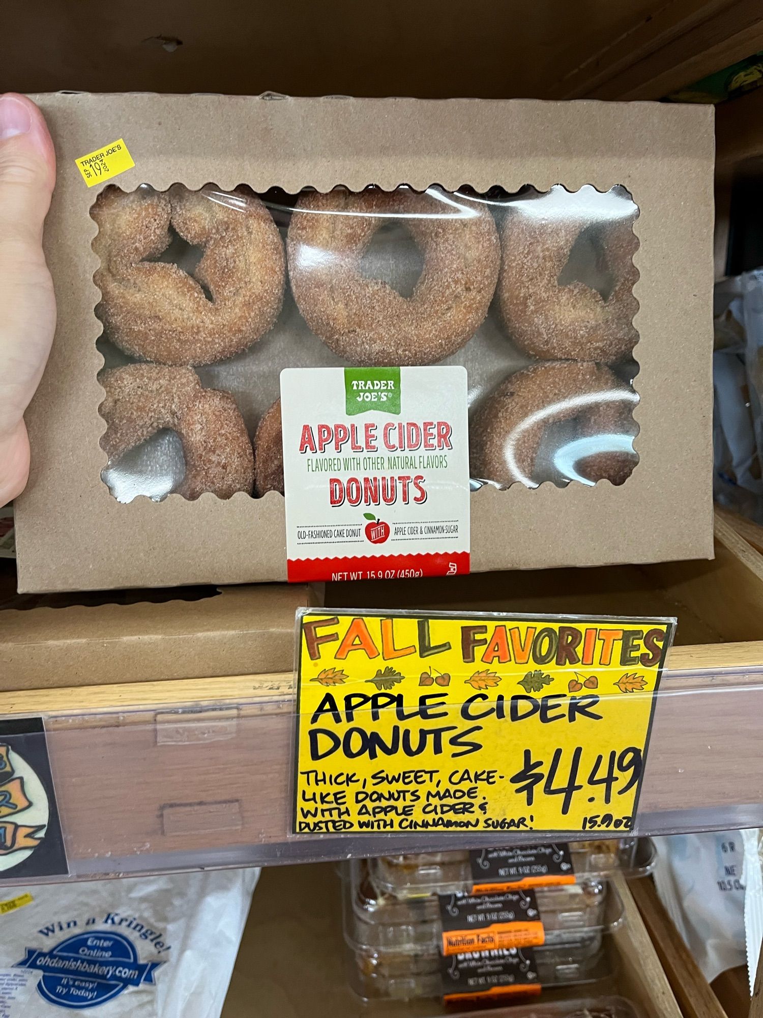 A box of Trader Joe’s cider donuts on the shelf at the store with the shelf notes.