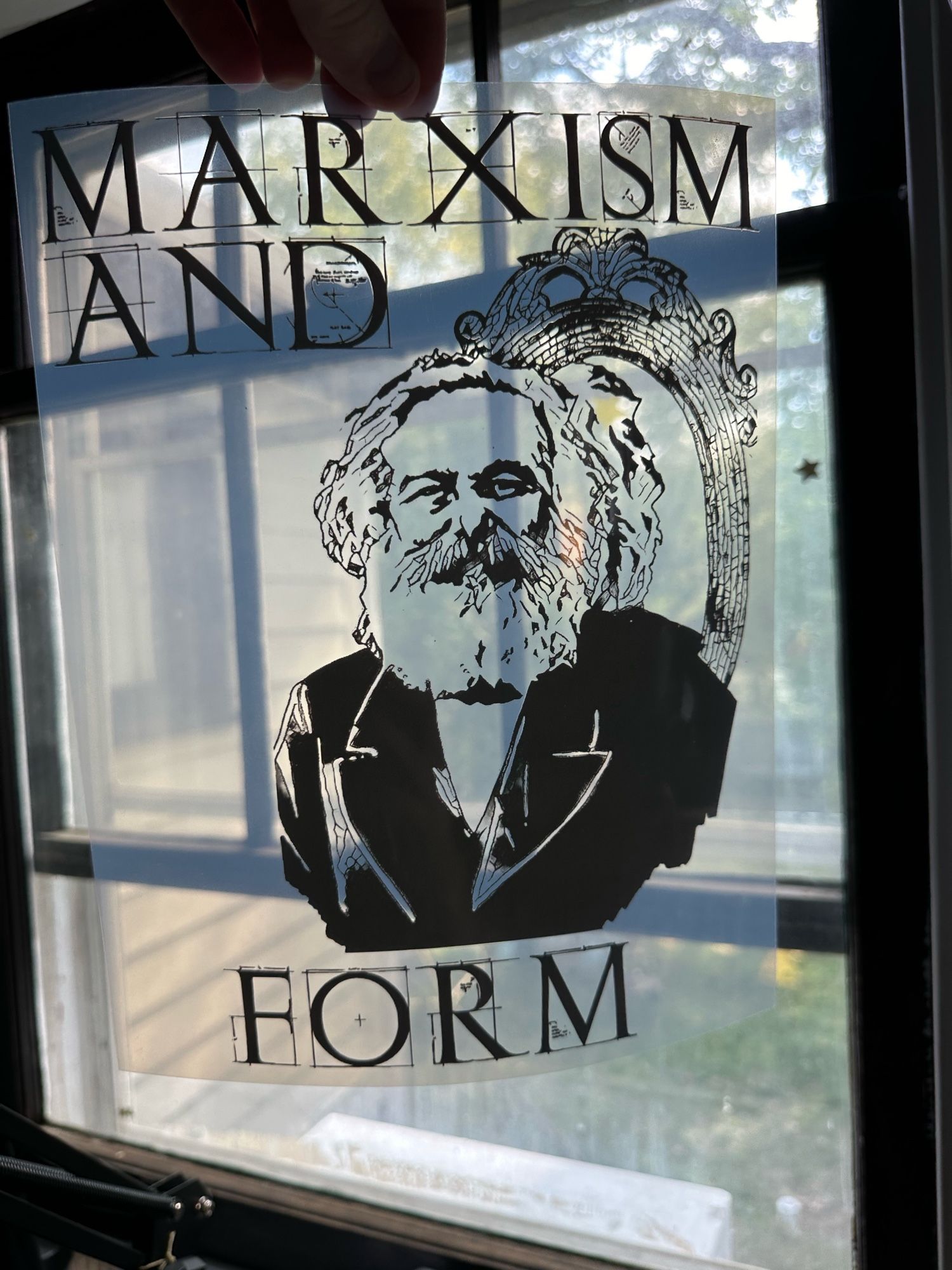 Transparency of marx in front of a mirror with the text marxism and form around in blueprint font.