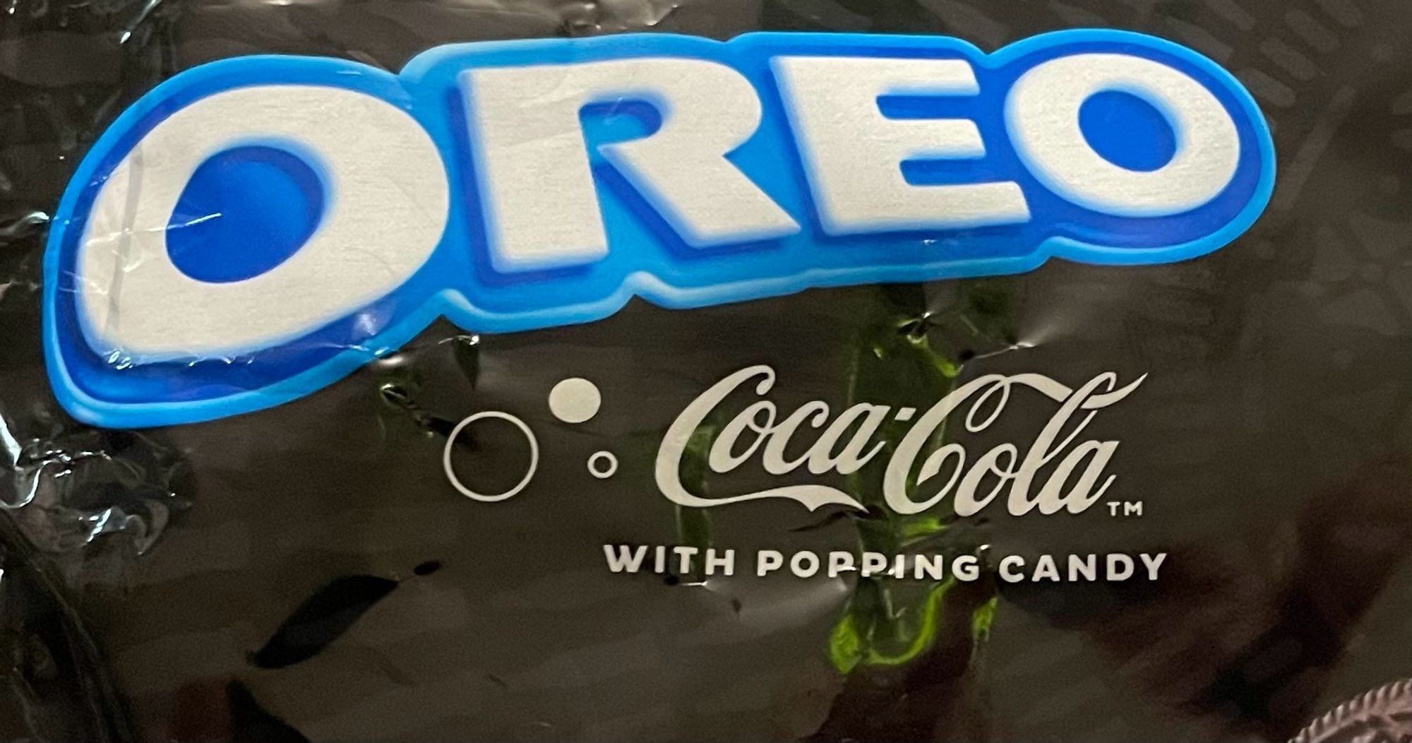 A close up on the label of a special edition bag of Coca-Cola Oreos with “popping candy”.