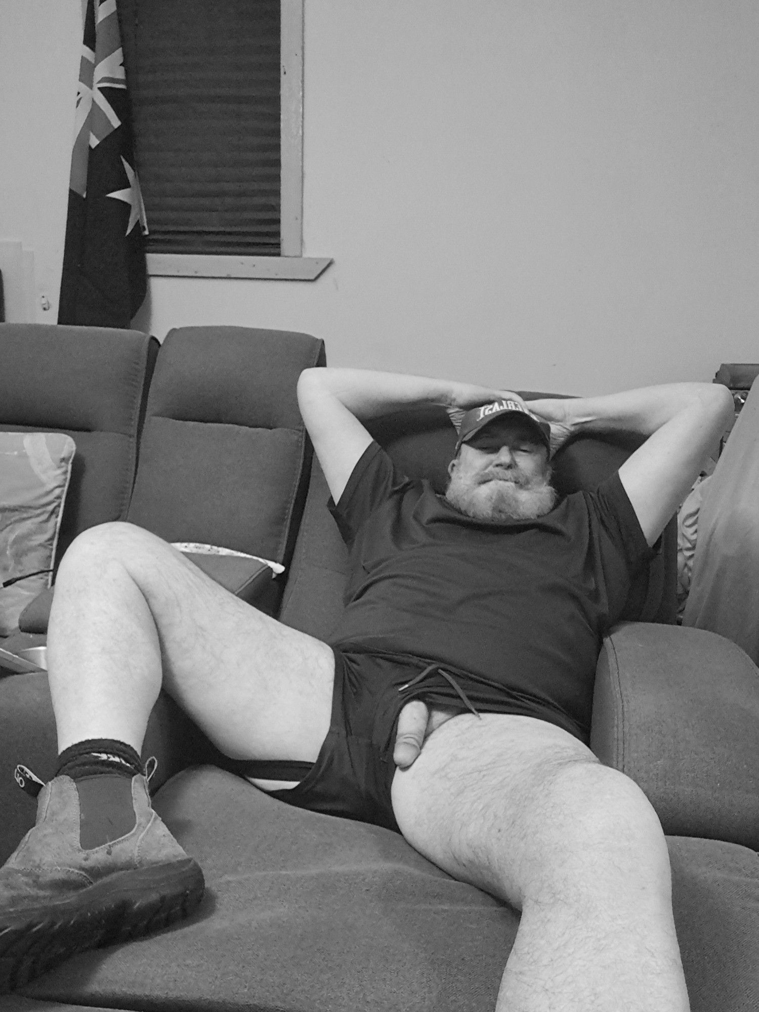 On the couch in tshirt shorts and boots