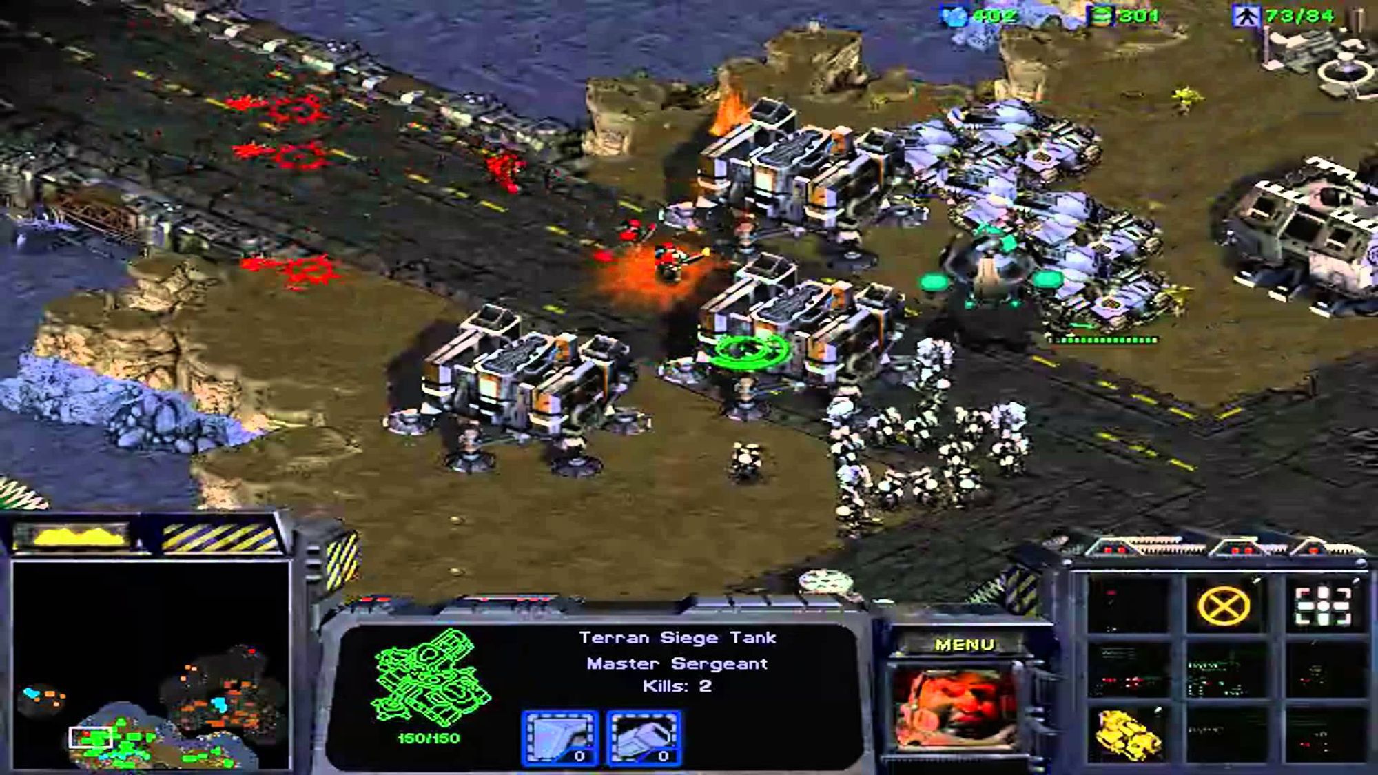 A gameplay screenshot from StarCraft showing off the Terrans, the human race. There are some buildings and some marines, aircraft, and tanks.