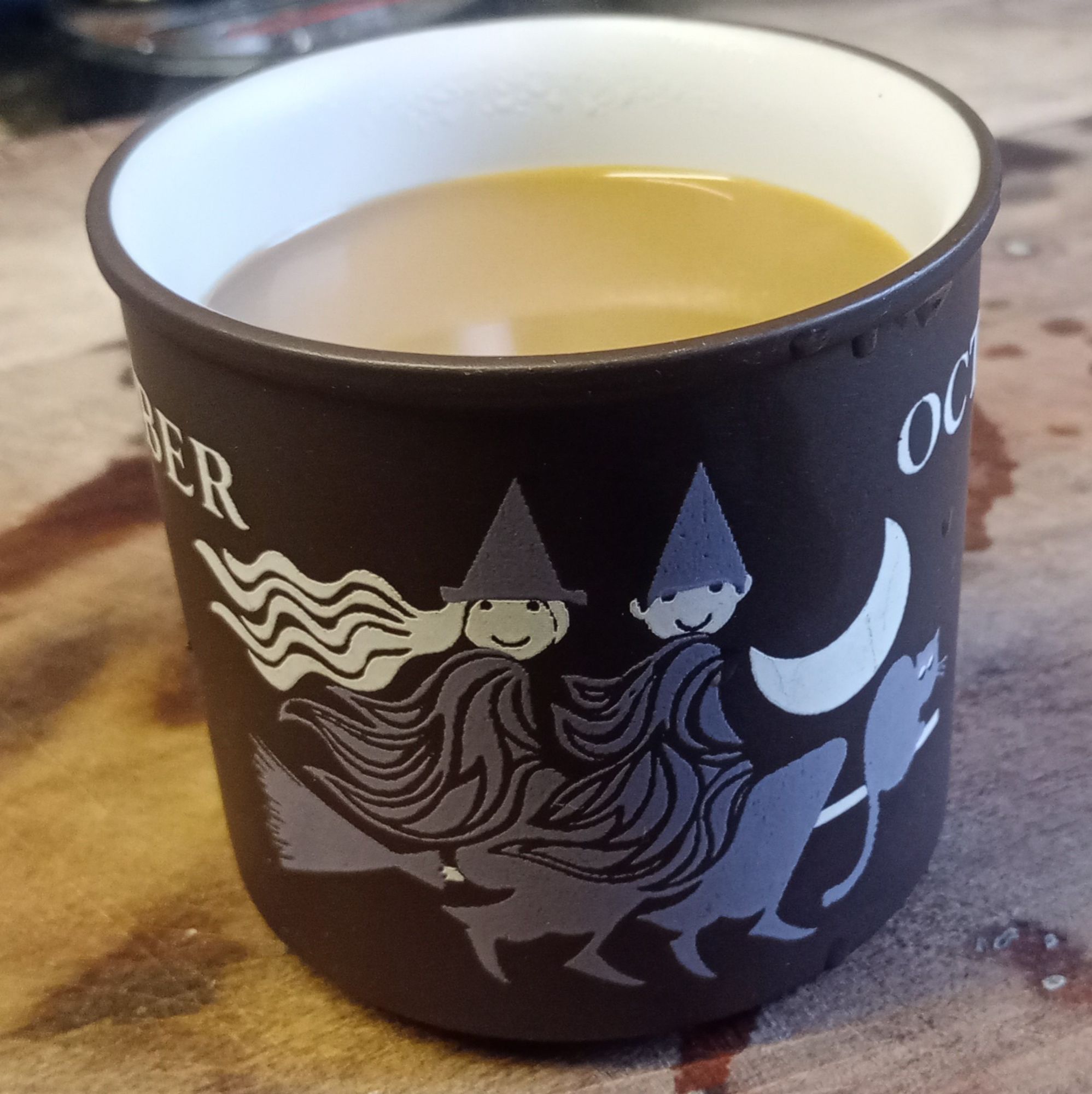 A witch and a warlock on a mug