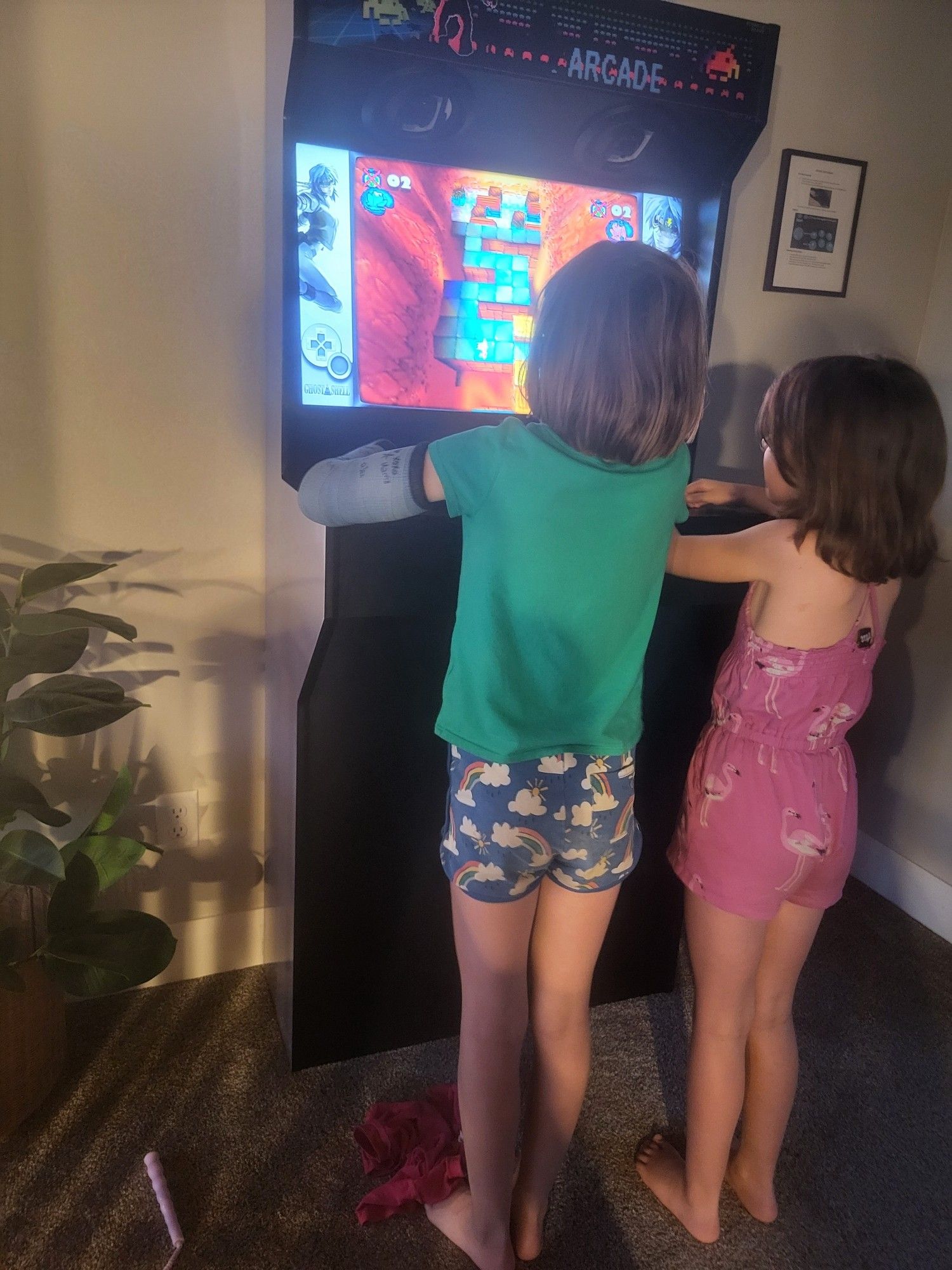 Kids playing an arcade game