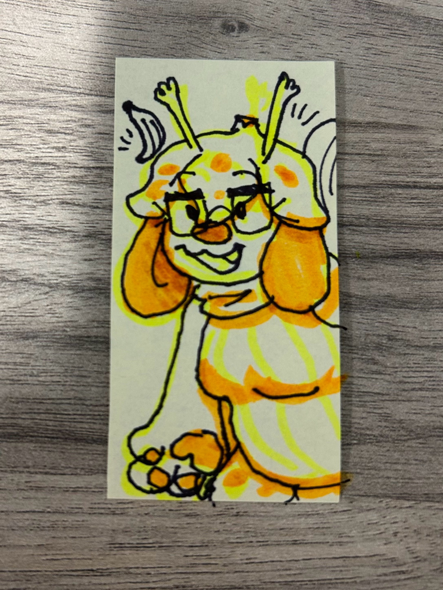 A pen drawing on a slim sticky-note of Split, highlighted and shaded with yellow and orange highlighter.