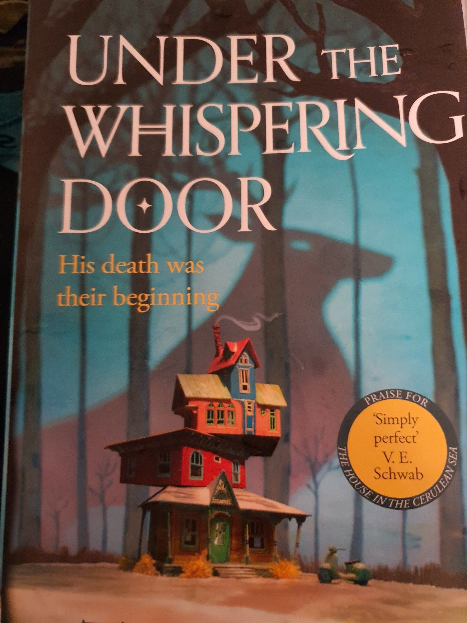 photo of the cover of "under the whispering door" by tj klune