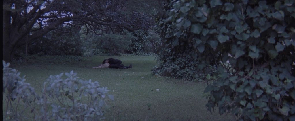 A vampire woman feeding in the middle of the castle grounds 