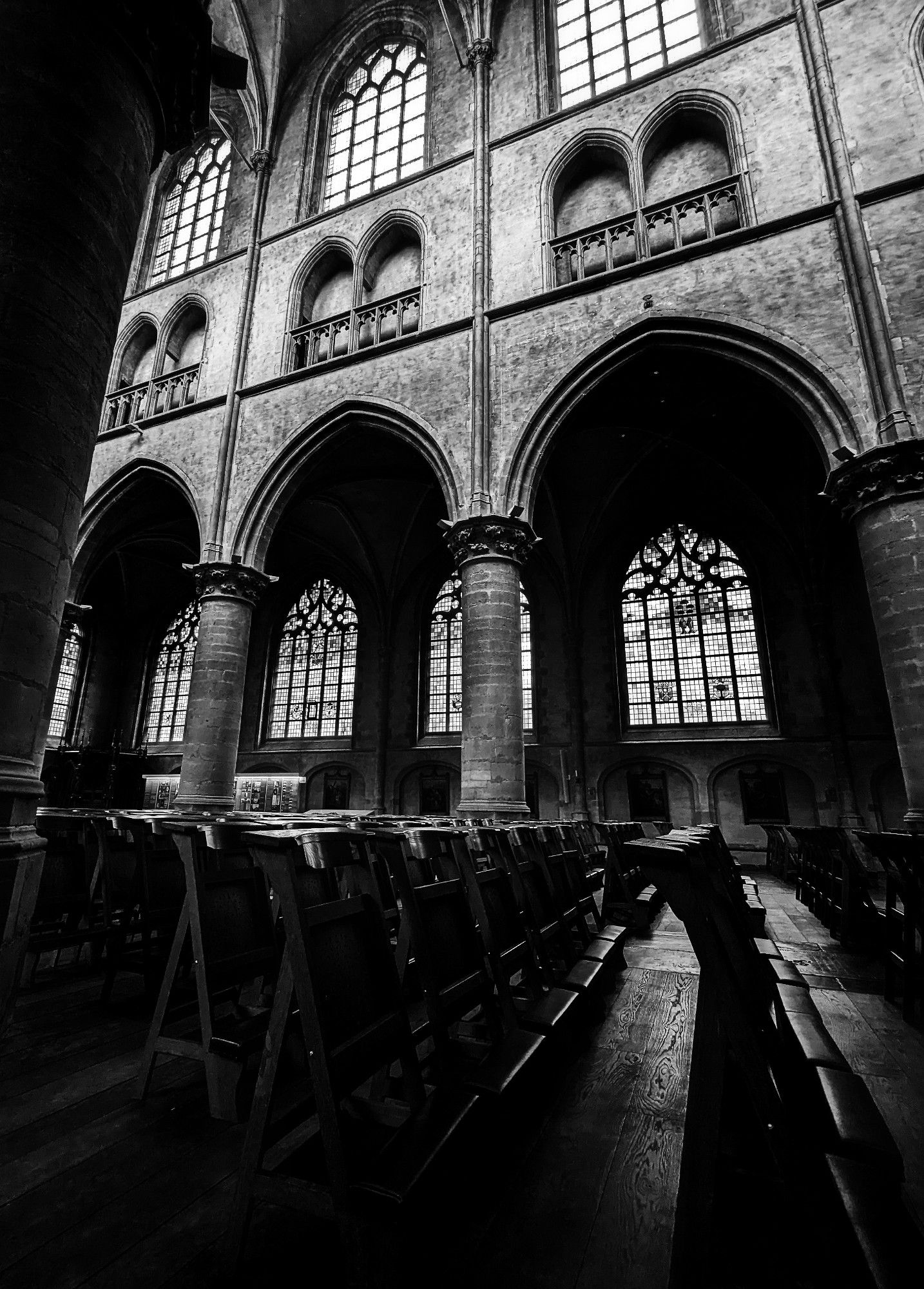 B&W
Inside church, looking up. Pillars, stained glass windows, benches in the shadows.