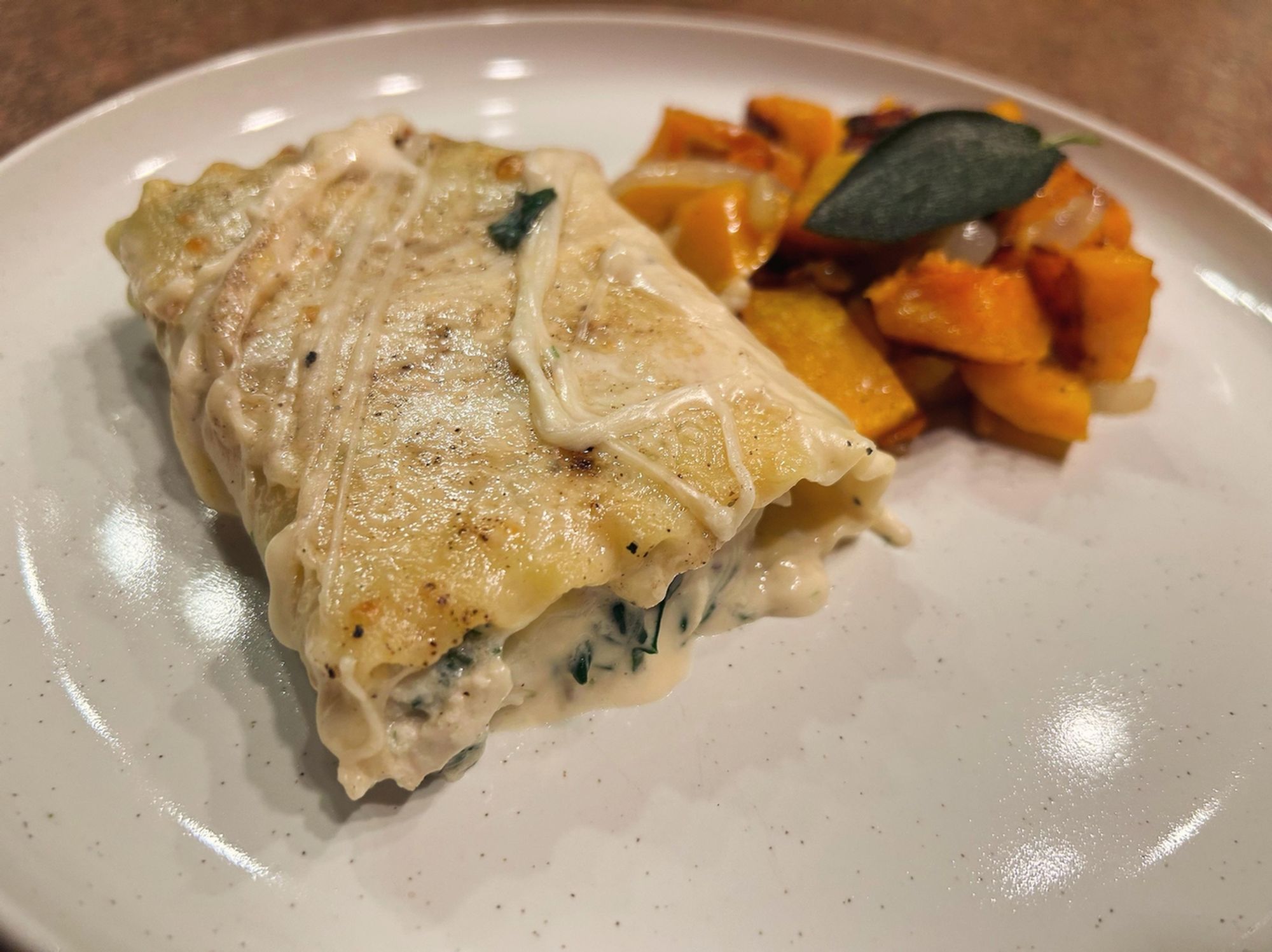 Image from Reddit post titled '[homemade] Chicken and spinach Alfredo roll ups with maple roasted butternut squash with pine nuts and fried sage. ' by SheShmokes.