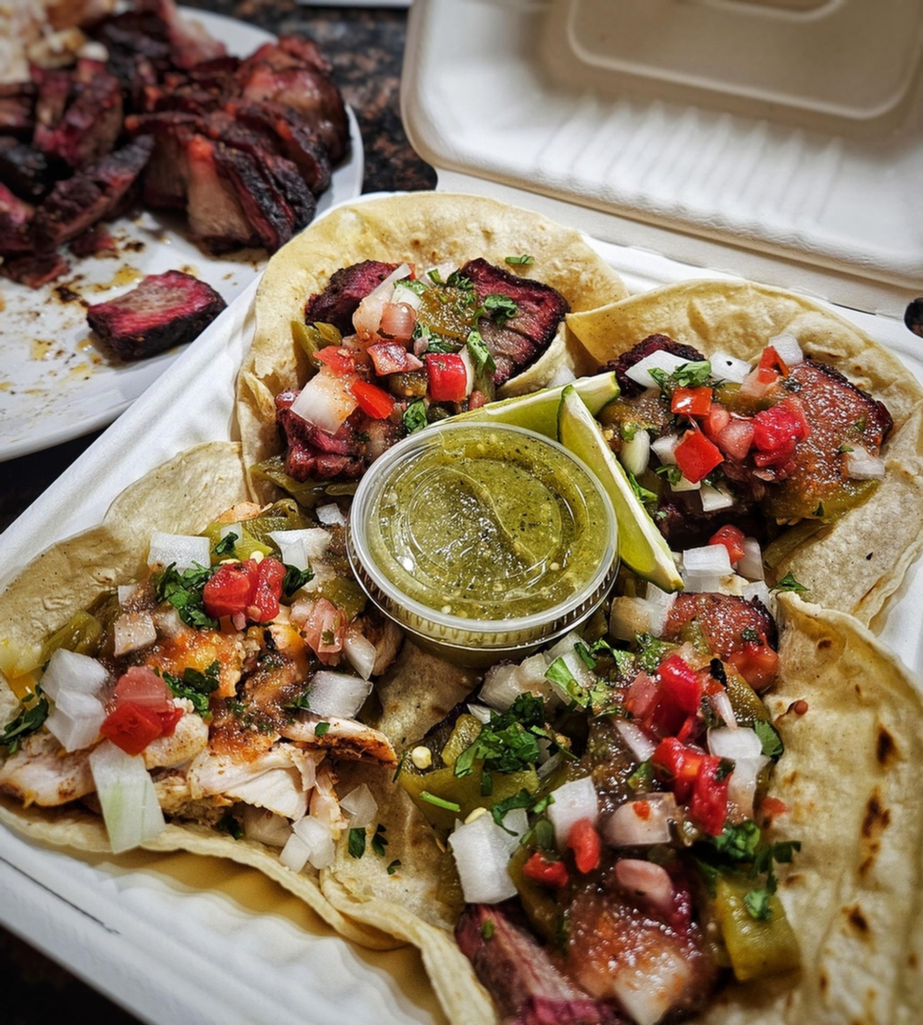 Image from Reddit post titled '[homemade] Smoked chuck roast tacos. And 1 smoked chicken taco. Roasted Hatch chile, cilantro and onion, fresh red and green salsa, pico de gallo, and lime.' by Notorious2again.