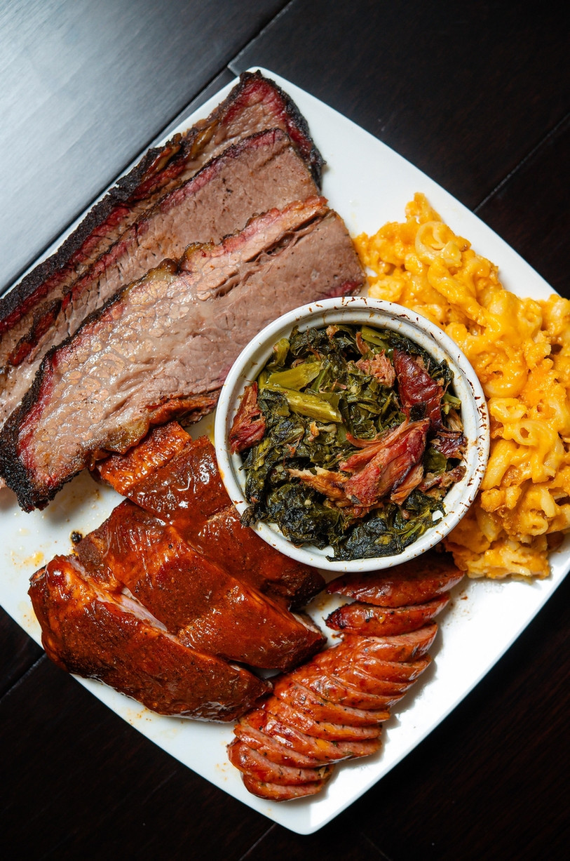 Image from Reddit post titled '[homemade] smoked ribs, brisket, Mac and cheese, collard greens and jalapeño cheddar sausage ' by ProjectA-ko.