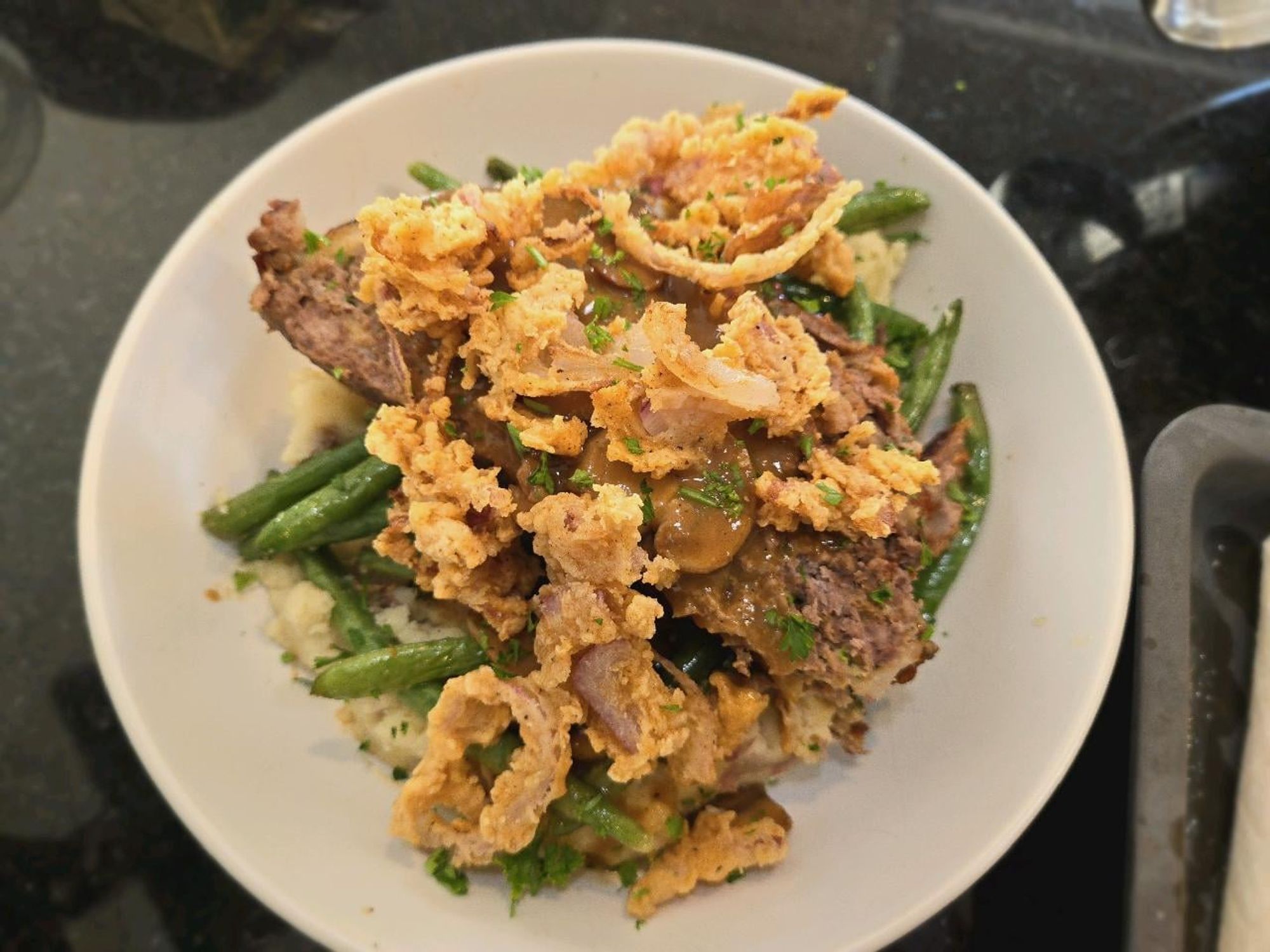 Image from Reddit post titled '[Homemade] Meatloaf, Mashed Baby Red Potatoes, Mushroom Gravy, Roasted Green Beans, and Fried Onions' by linkmaster117.