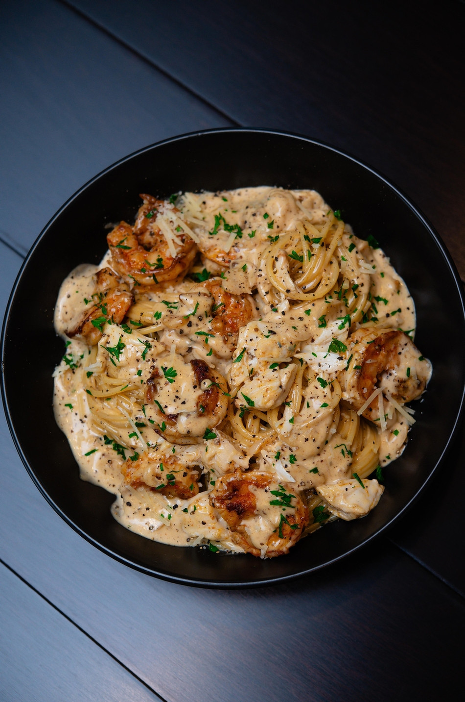 Image from Reddit post titled '[homemade] Blackened shrimp Alfredo with lump crab meat. ' by ProjectA-ko.