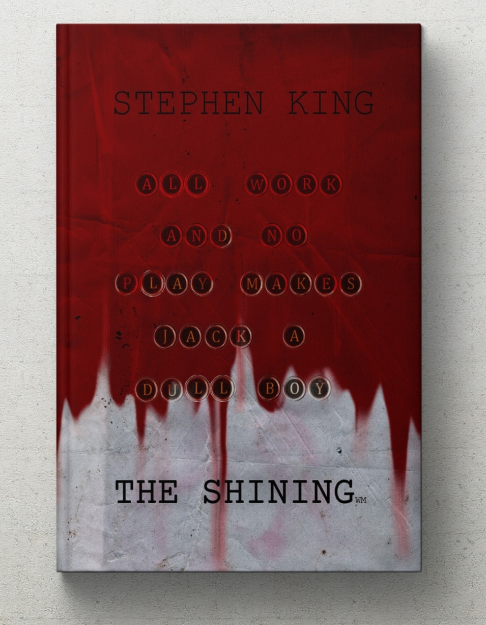 Book mockup of A graphic redesign for the cover of Stephen King's 'The Shining' where it is a roughed up paper texture being stained with dripping blood and typewriter keys that read 'All Work And No Play Makes Jack A Dull Boy'