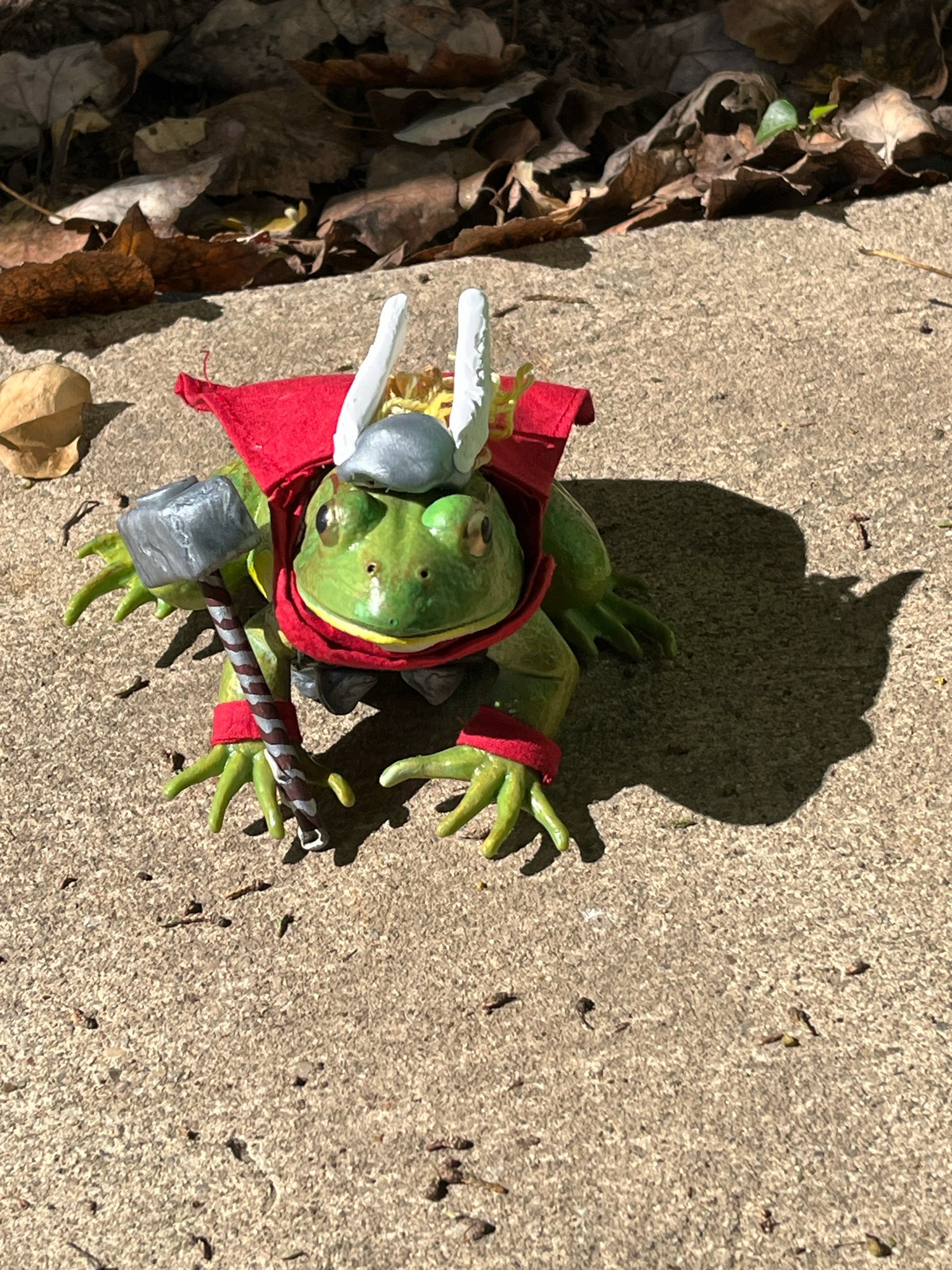 Thor frog: a plastic frog dressed as Thor with a winged helmet, red cape, and small Mjolnir.