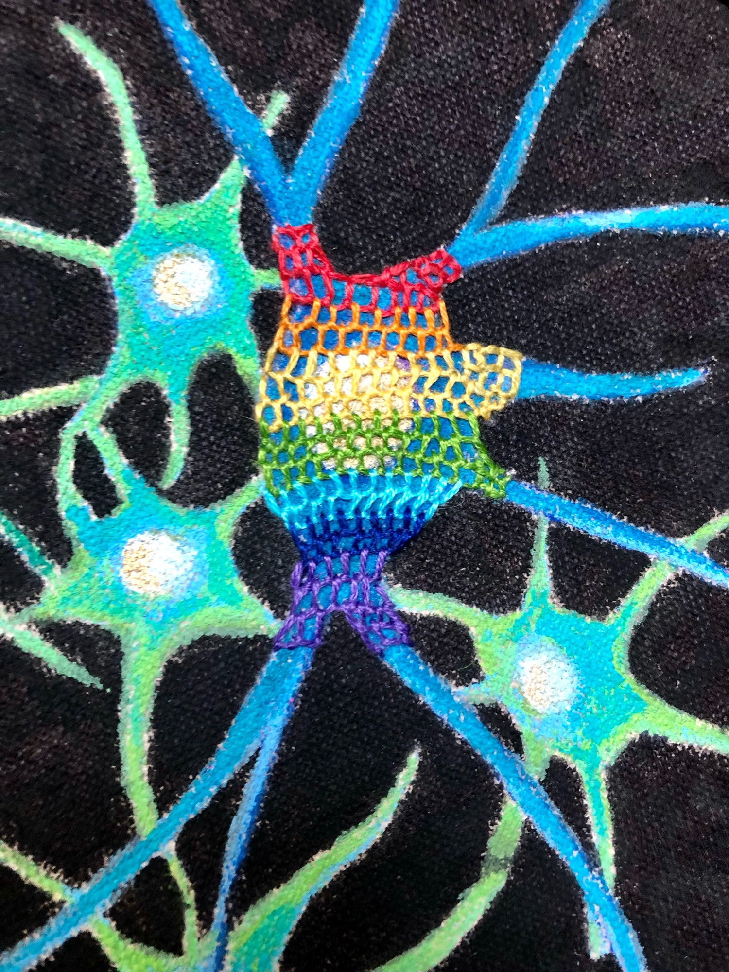 Close up of painted neurons and embroidered perineuronal network on top in rainbow threads