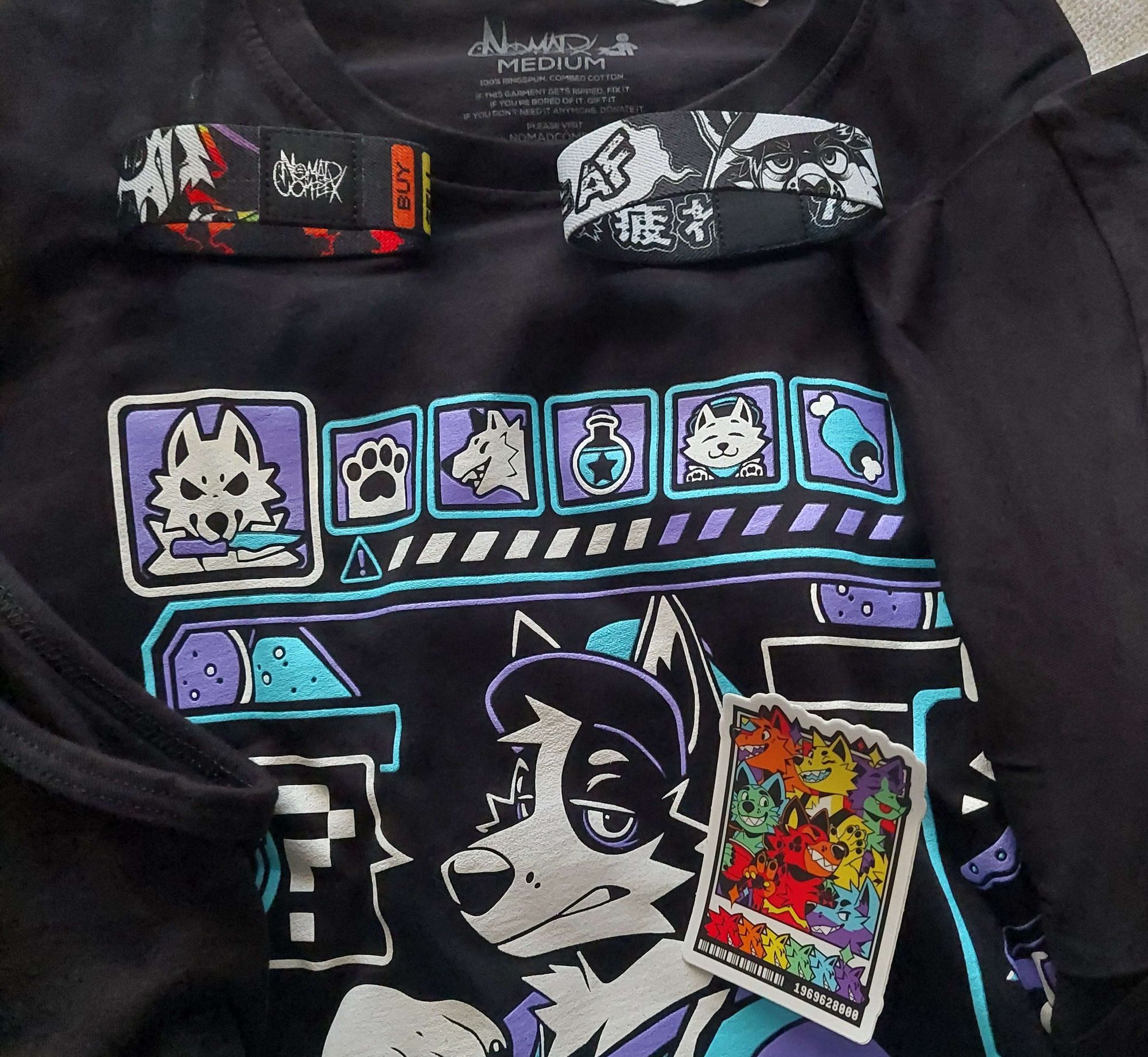 On top of the long sleeve Shopkeeper T-Shirt are two wristbands and one sticker. All three of these accessories are from the furry apparel store, Nomad Complex.

Wristbands - Rainbow Capitalism, Tired AF
Sticker - Pawlaroid