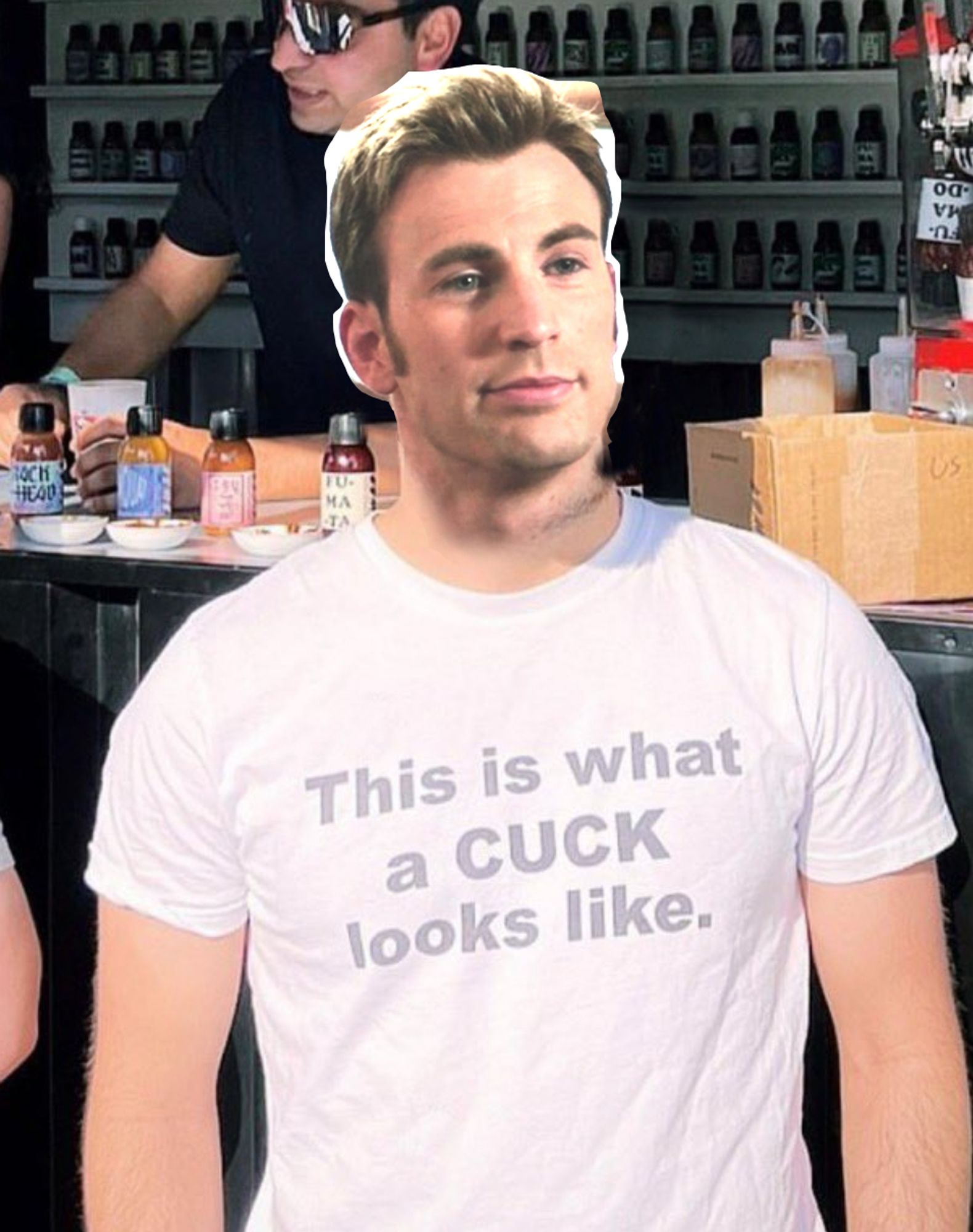 Steve Rogers (played by Chris Evans) head badly photoshopped over top of another man's body. His expression is mildly pleasant.
He's wearing a faded white t-shirt that says "This is what a CUCK looks like."