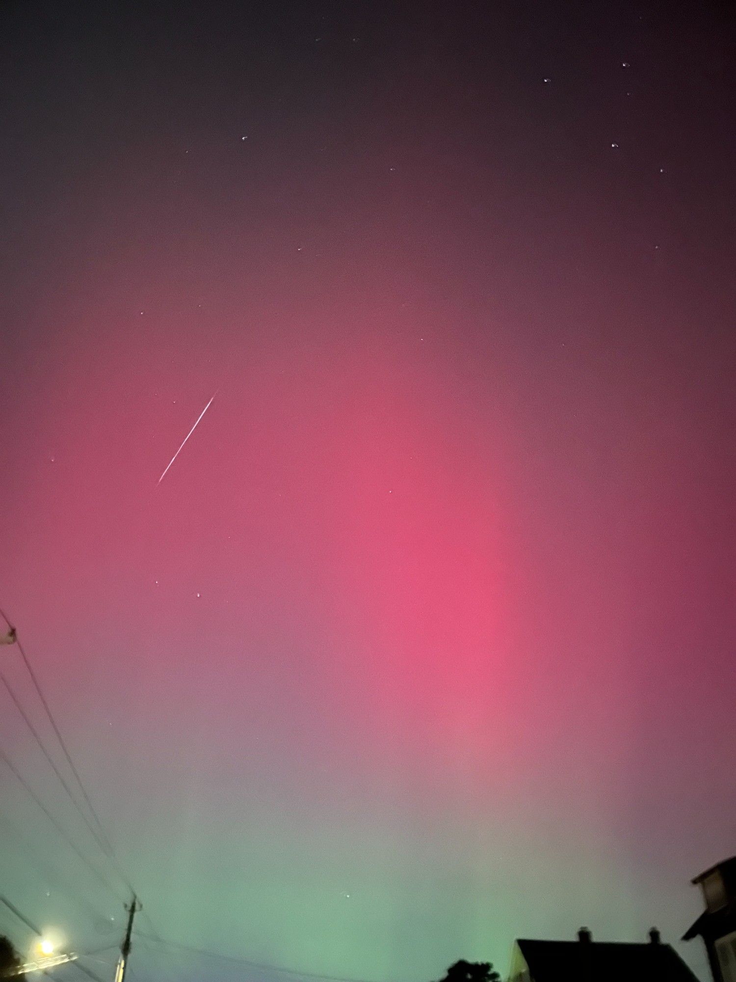 green and pink aurora with shooting star streak